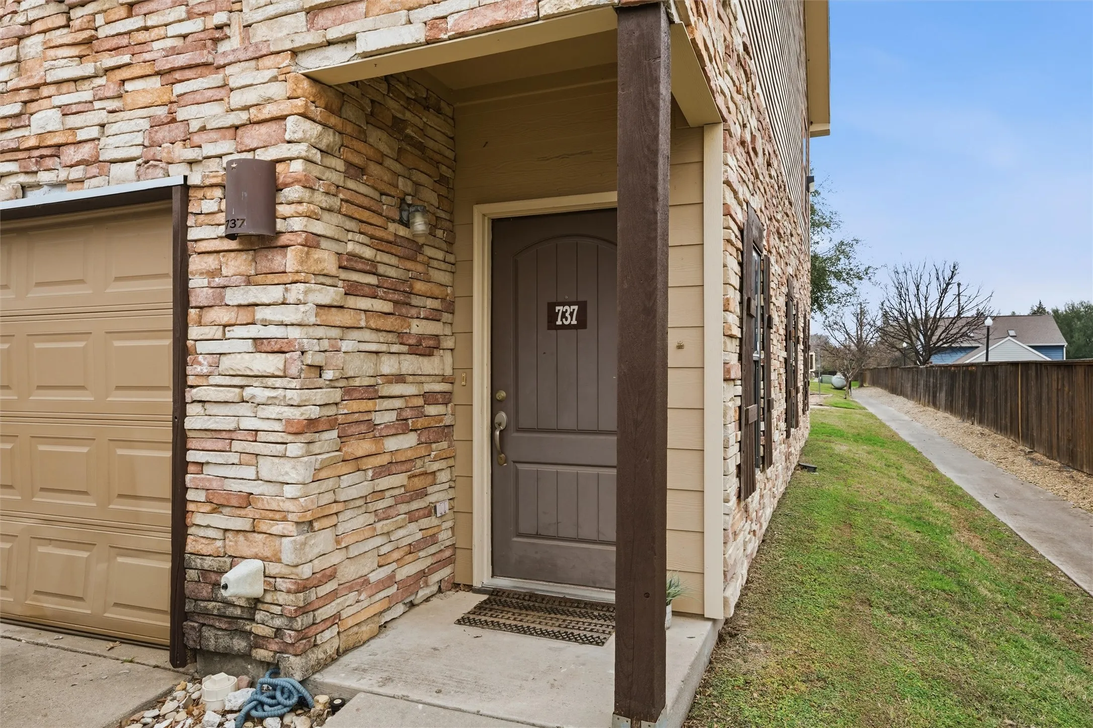 front door with covered porch 2 car garage front entry