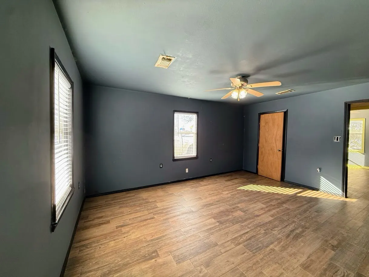 Unfurnished bedroom with wood finished floors and ceiling fan