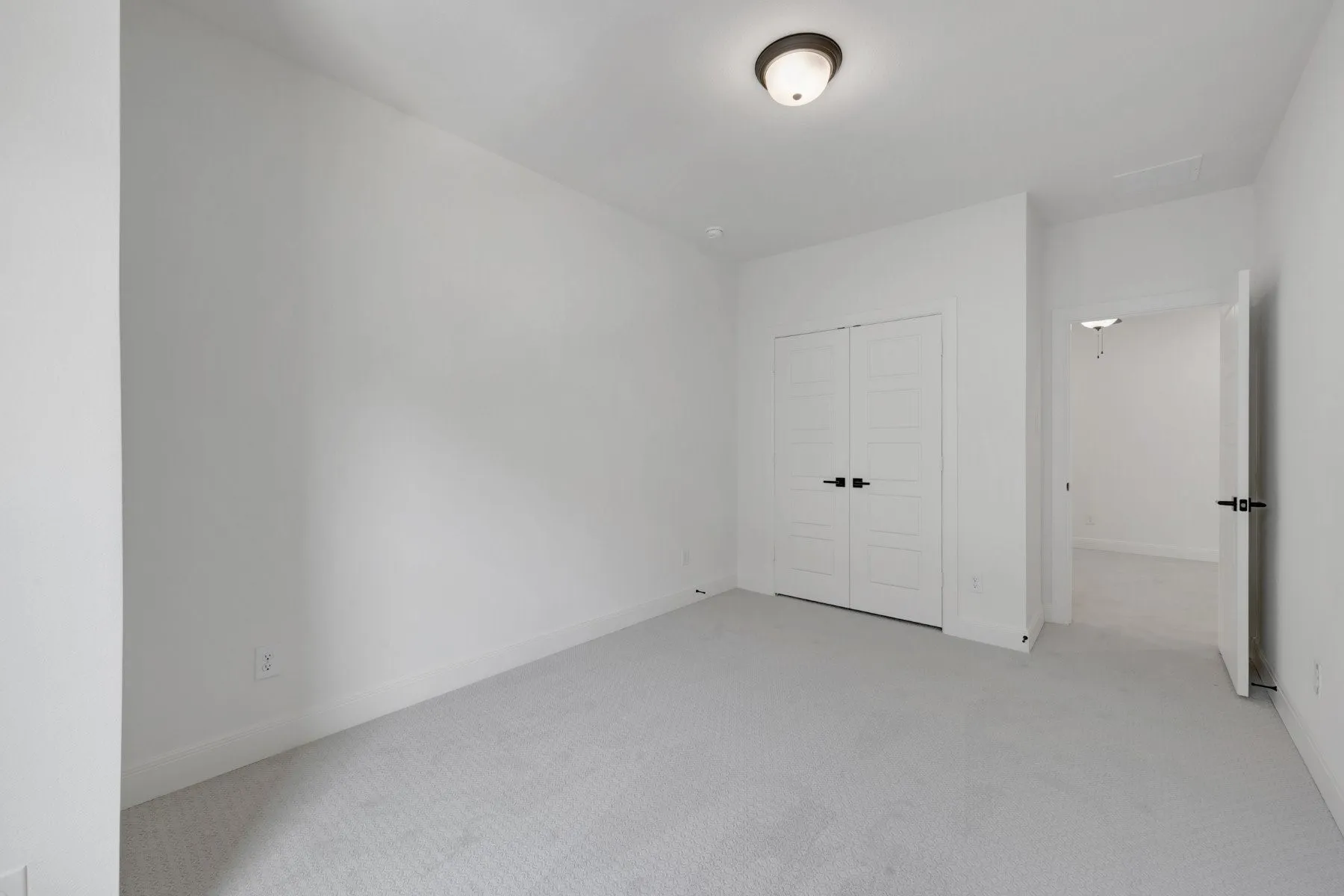 Carpeted room featuring white walls, white trim, and a white ceiling