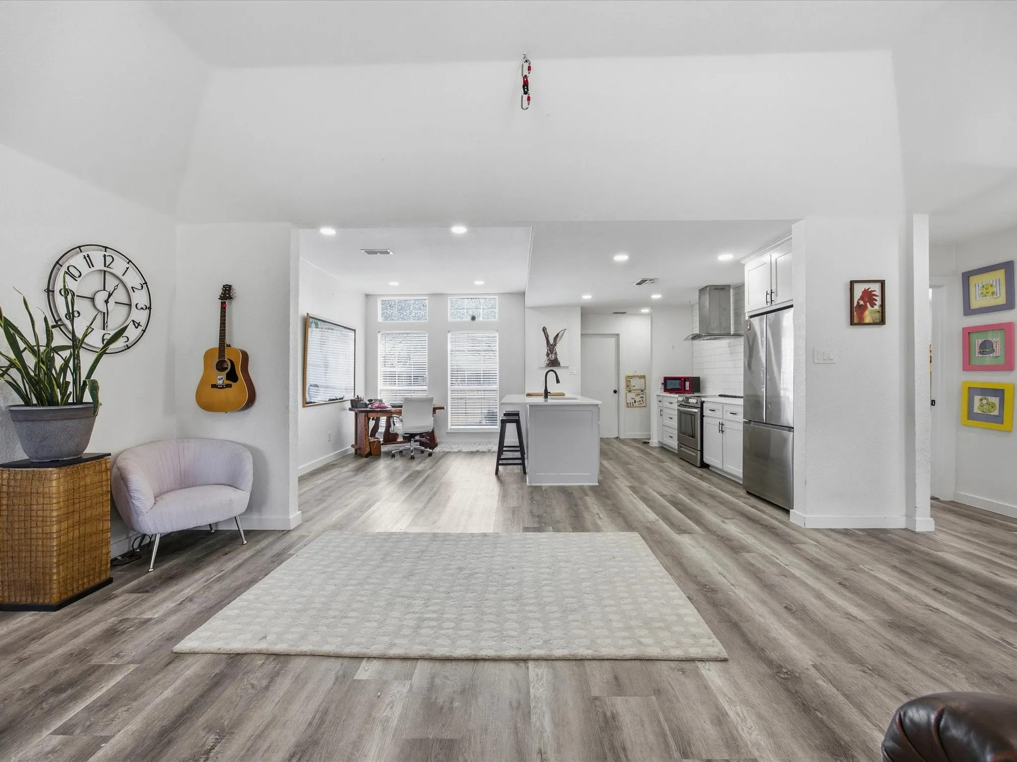 Living area featuring light wood finished floors and recessed lighting