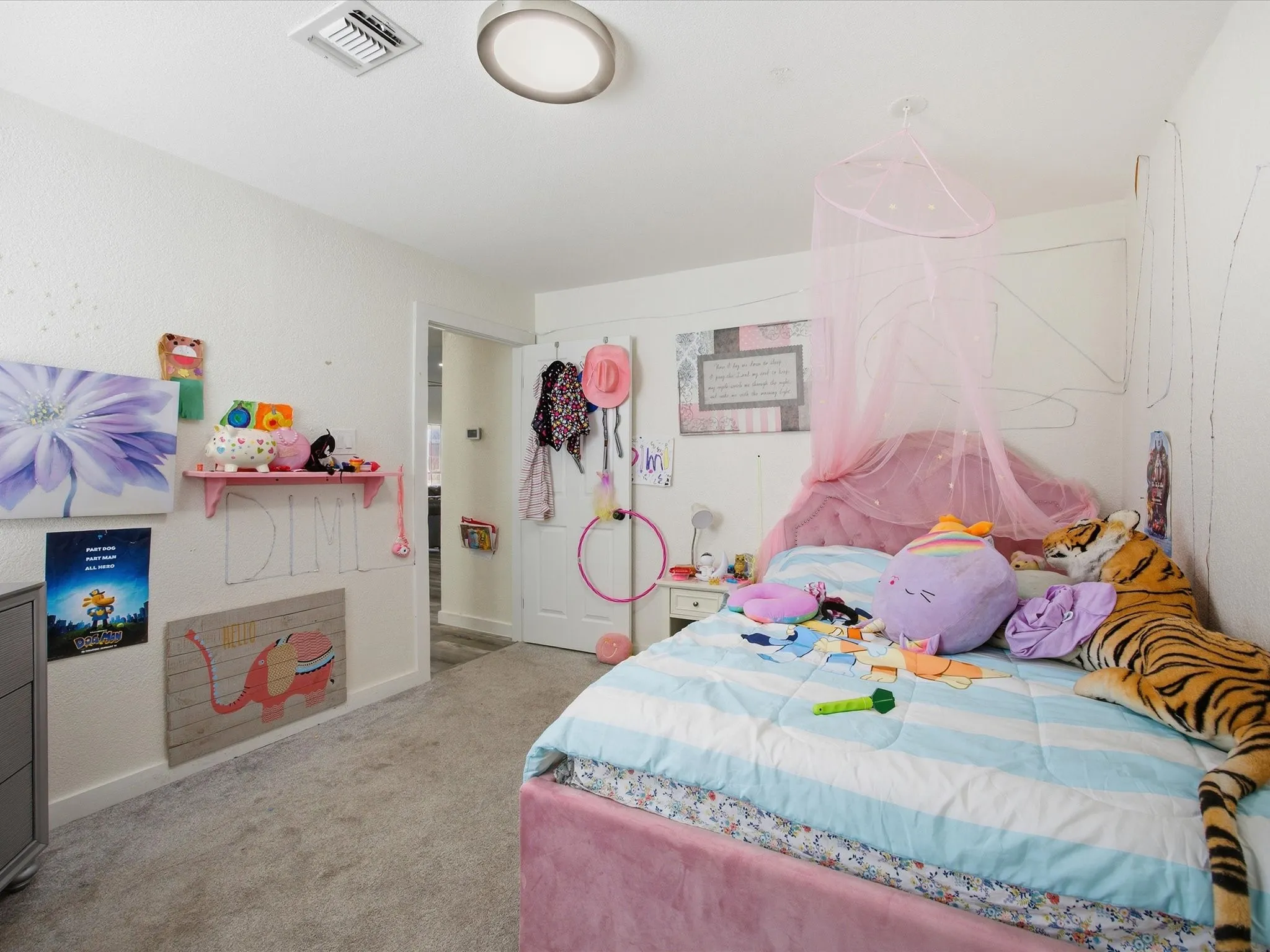 Bedroom with light colored carpet and baseboards
