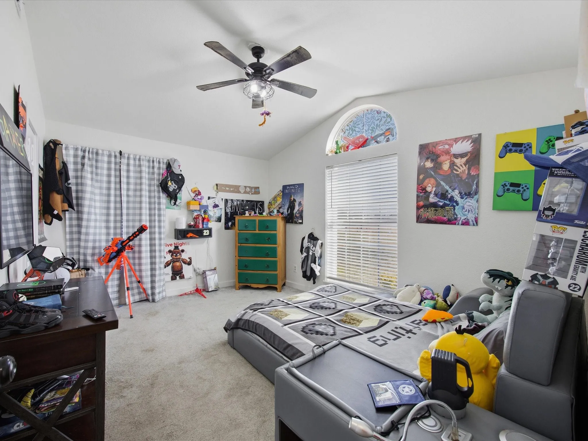 Bedroom featuring vaulted ceiling, light carpet, and ceiling fan