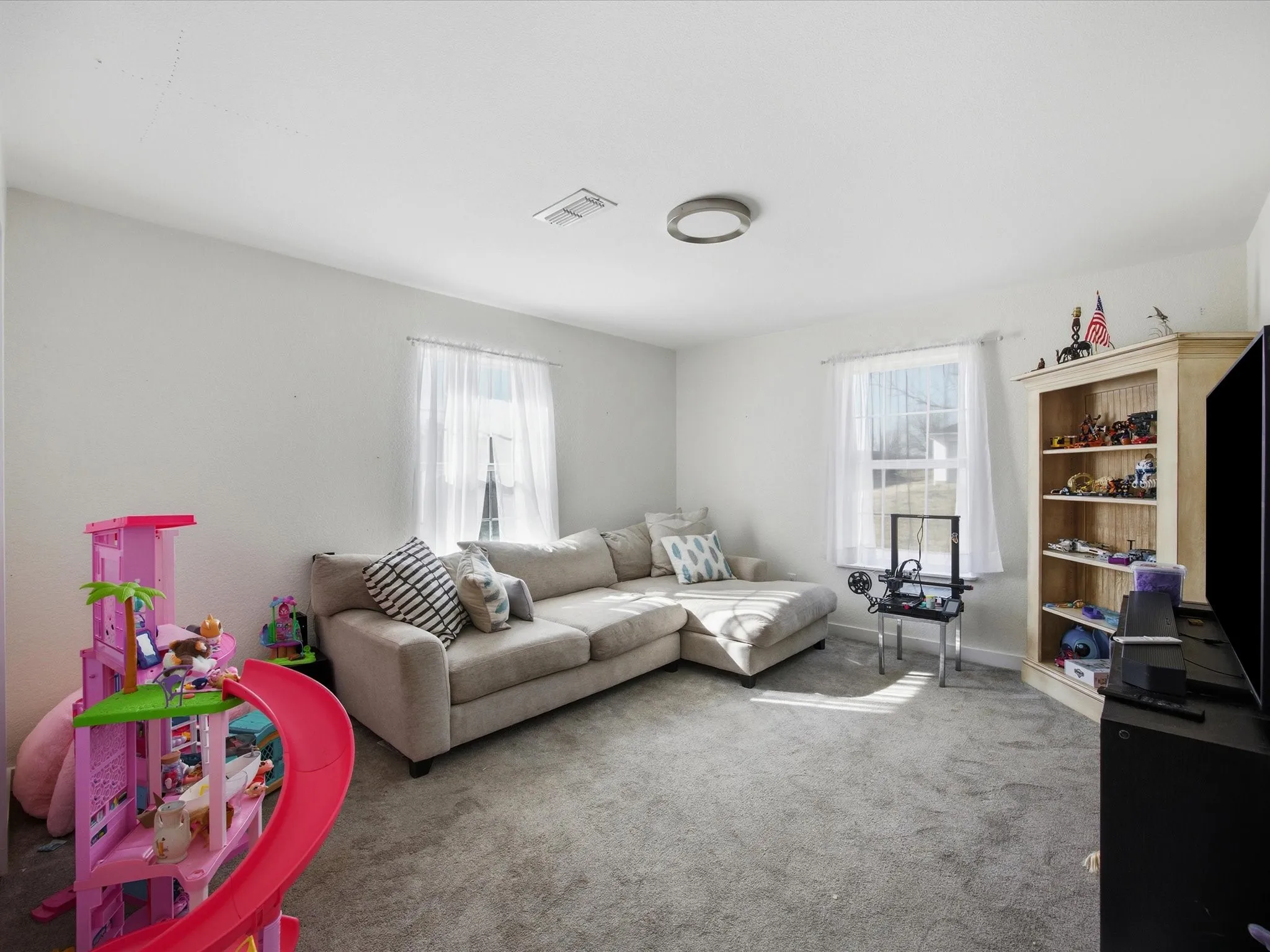 Extra room, being used as a living room. Can be used as an office, gym, game room, movie room, or bedroom.