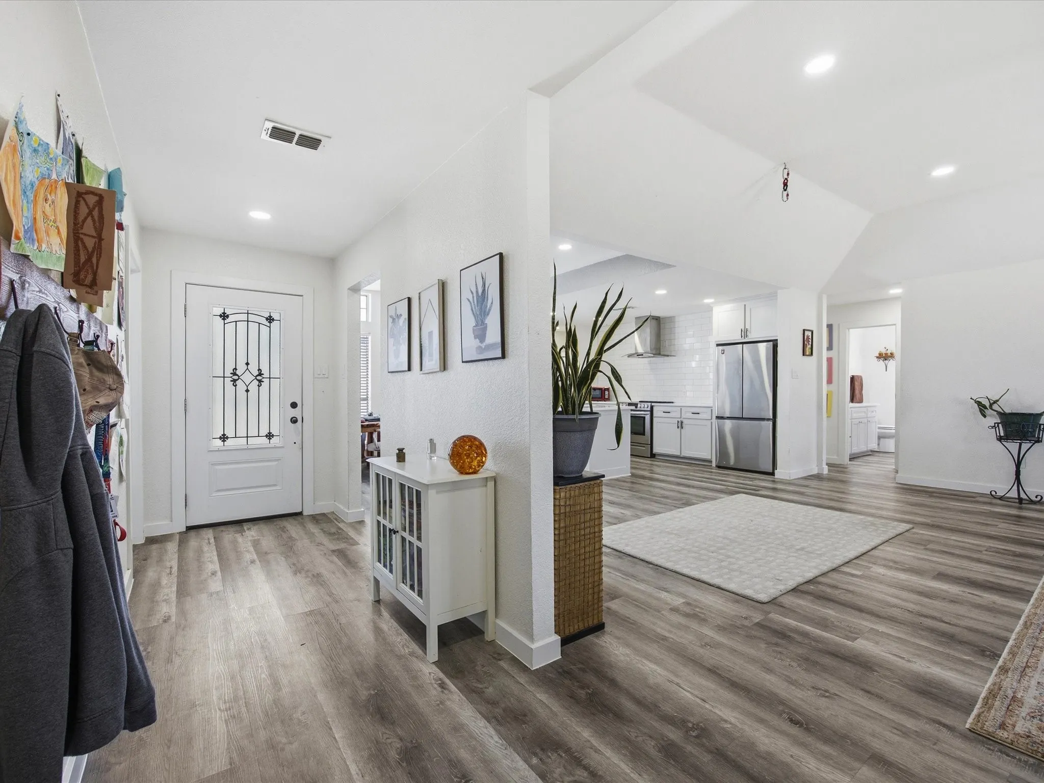 Entryway featuring light wood-style floors and recessed lighting