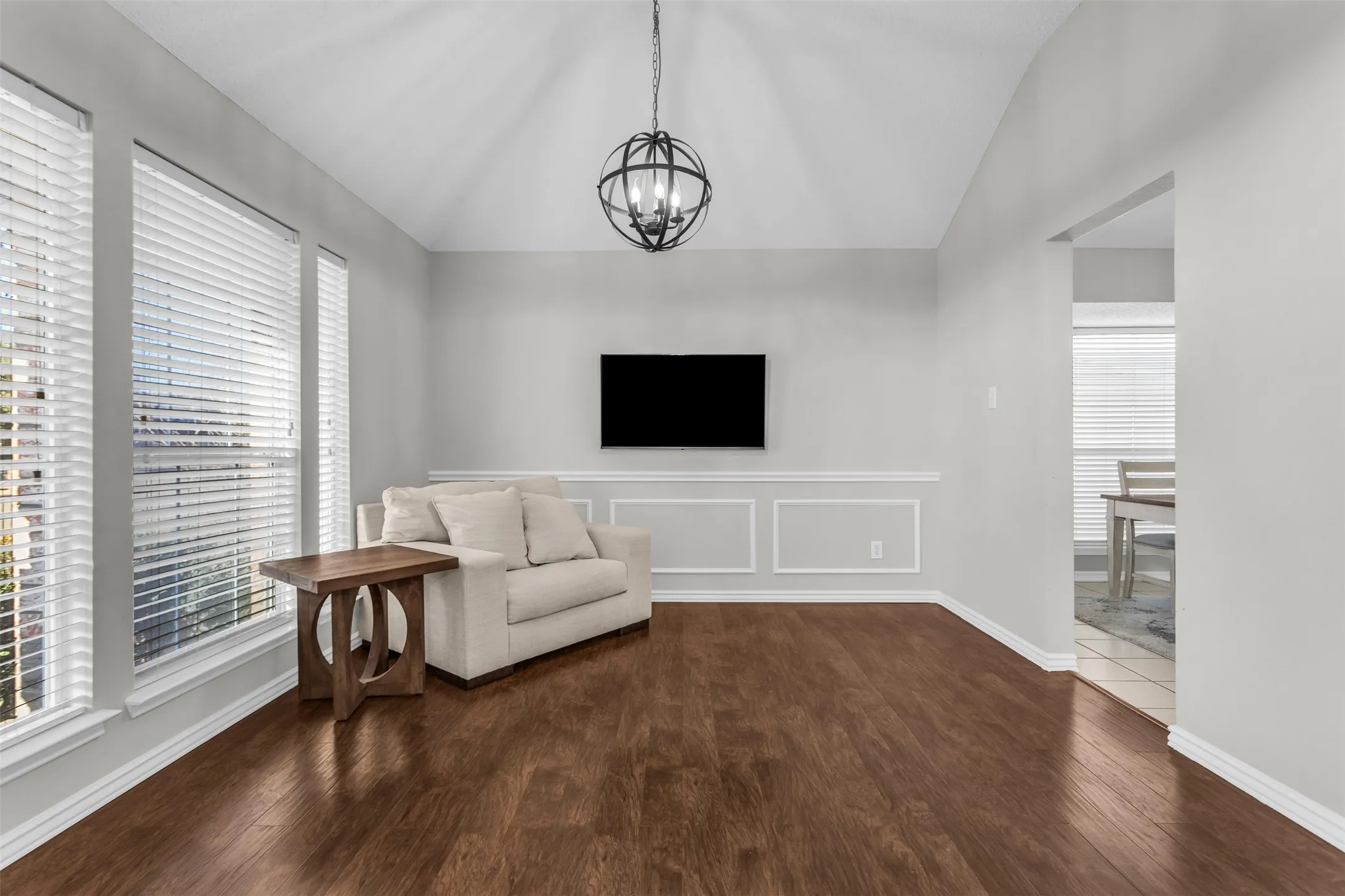 Cozy sitting area or home office space filled with natural light from large floor-to-ceiling windows.