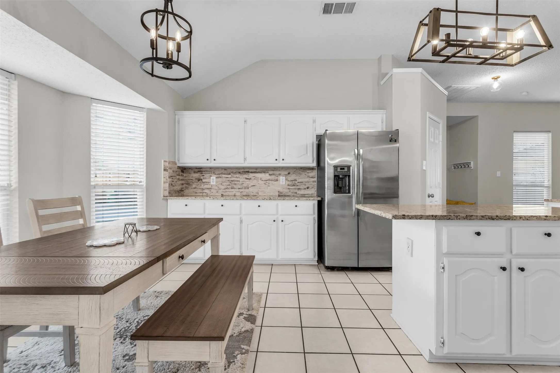 Functional kitchen island setup with custom tile work, smooth countertops, and ample prep space.