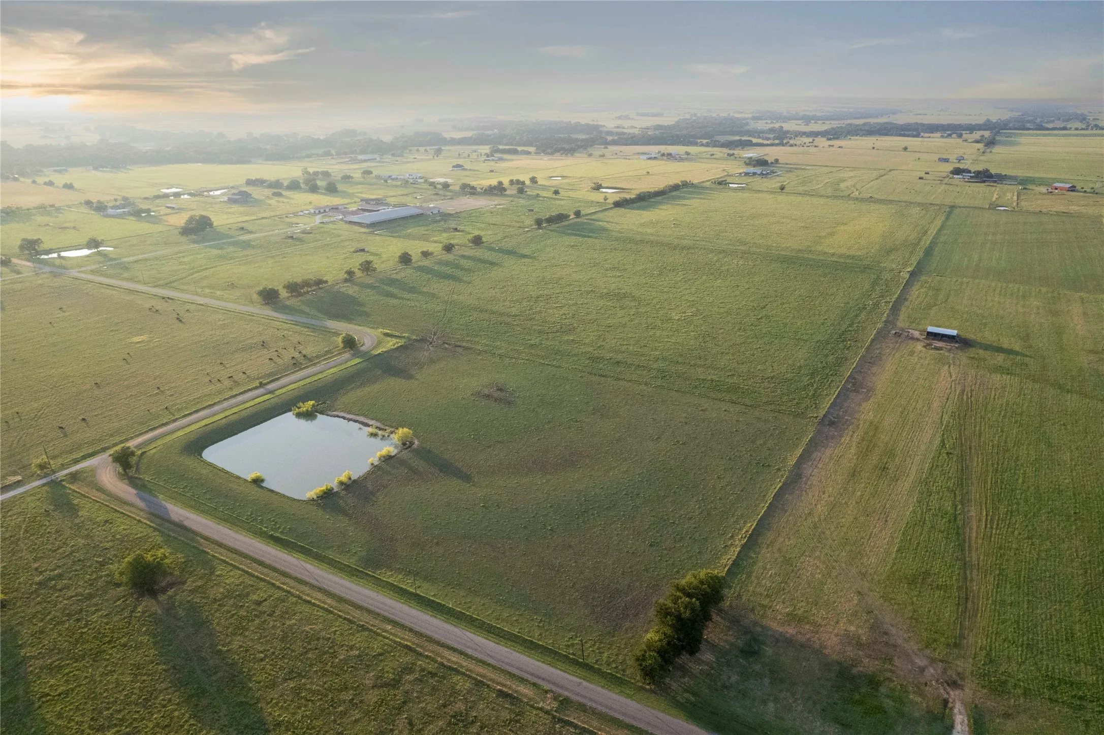 Aerial overview of property's location featuring rural landscape, a nearby body of water, and abundant farmland
