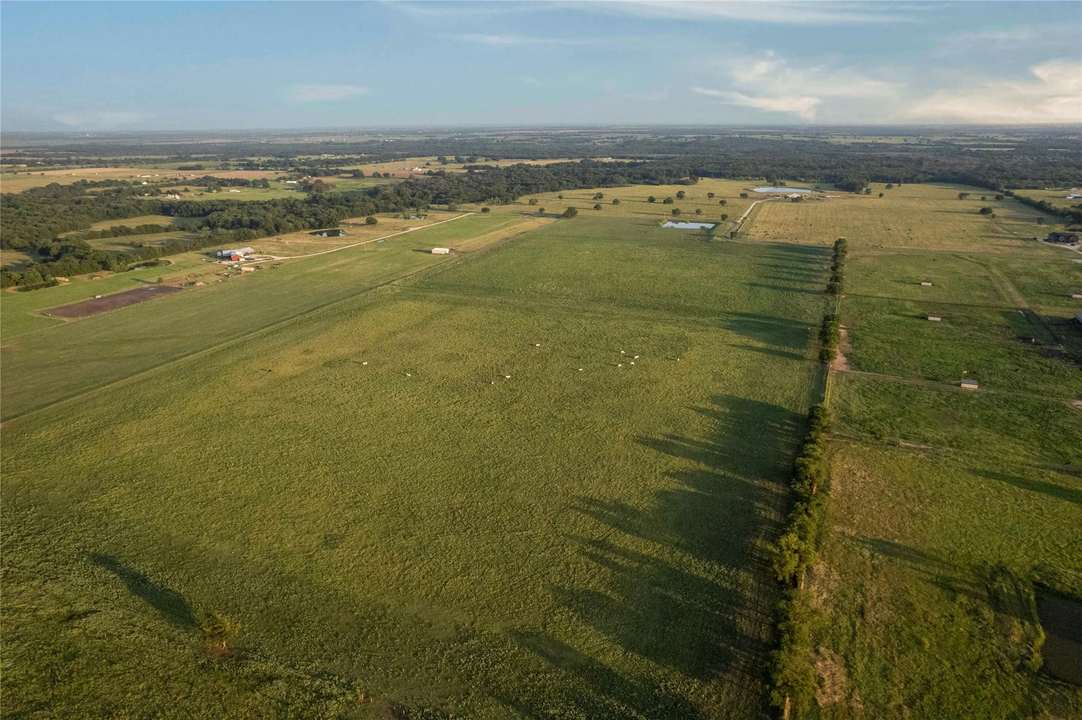 Aerial overview of property's location with rural landscape and extensive farmland