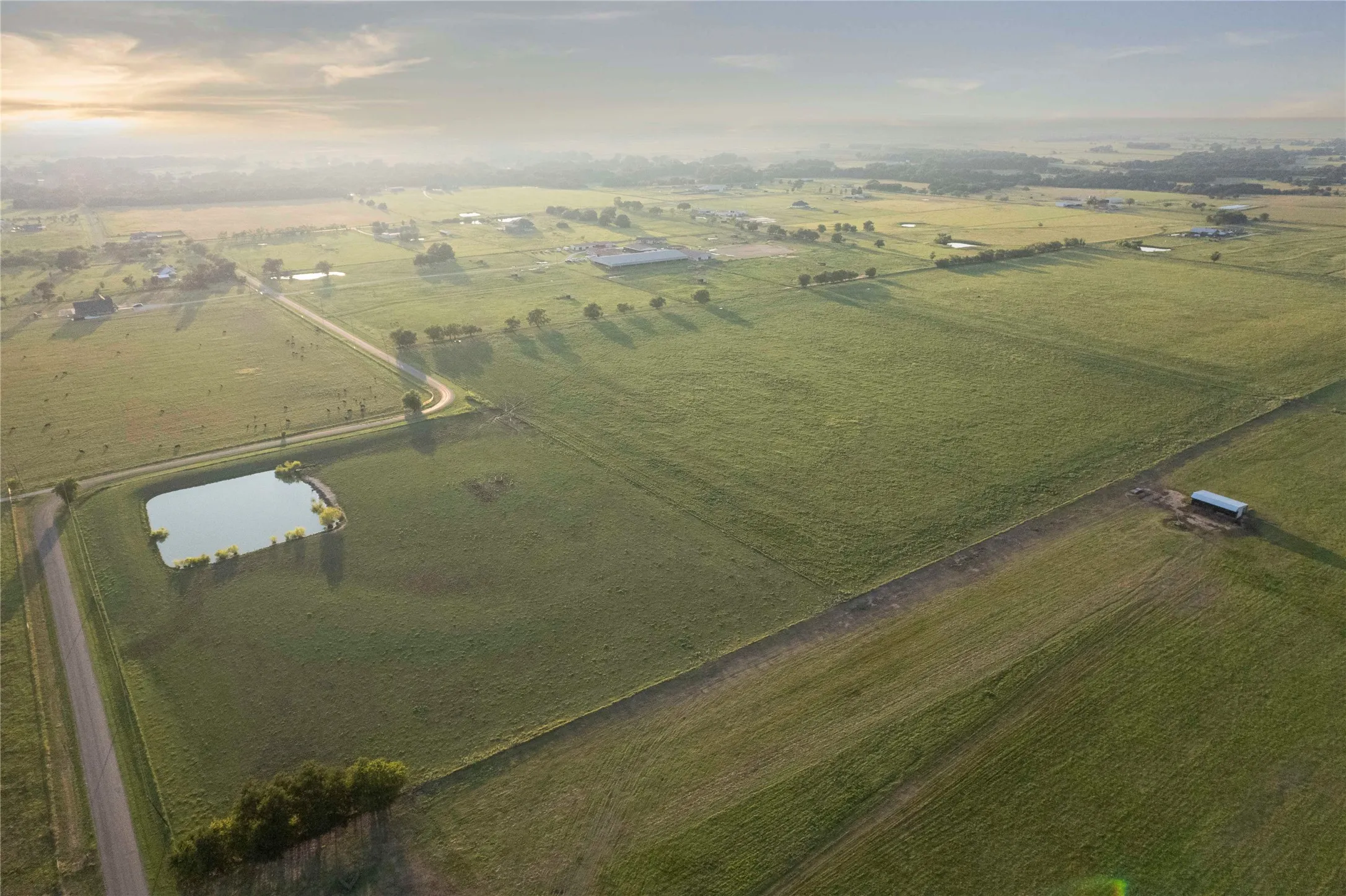 Aerial view of property's location with rural landscape and a large body of water
