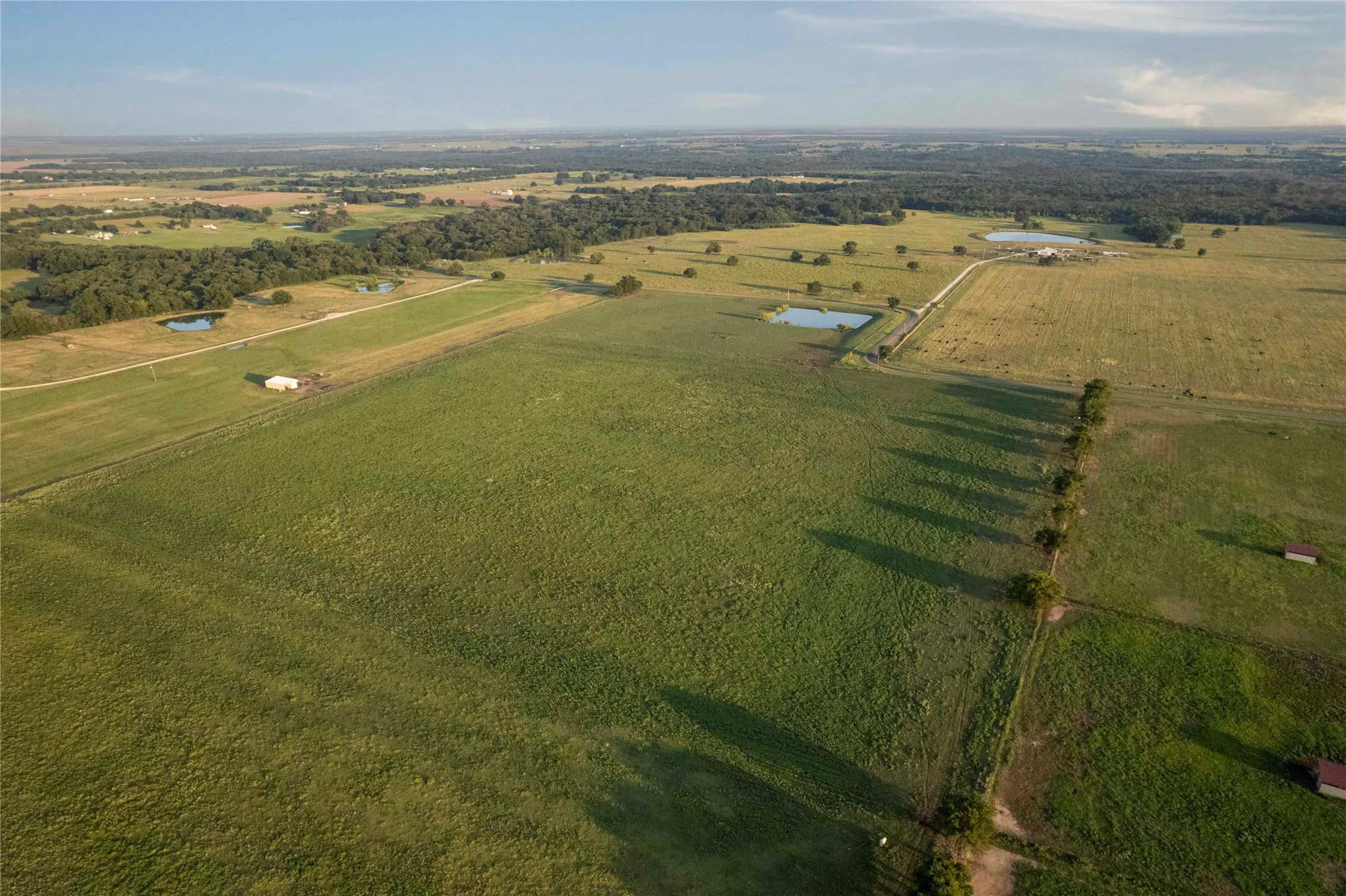 Aerial overview of property's location with rural landscape and rows of crops
