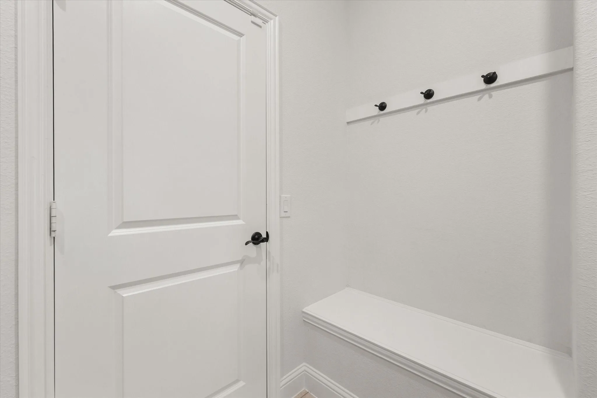 Hooks & seating in laundry room