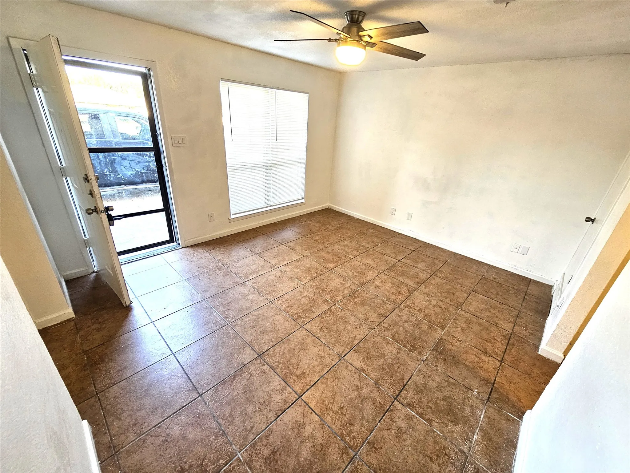 Family/Living room with new fresh paint and new ceiling fan.