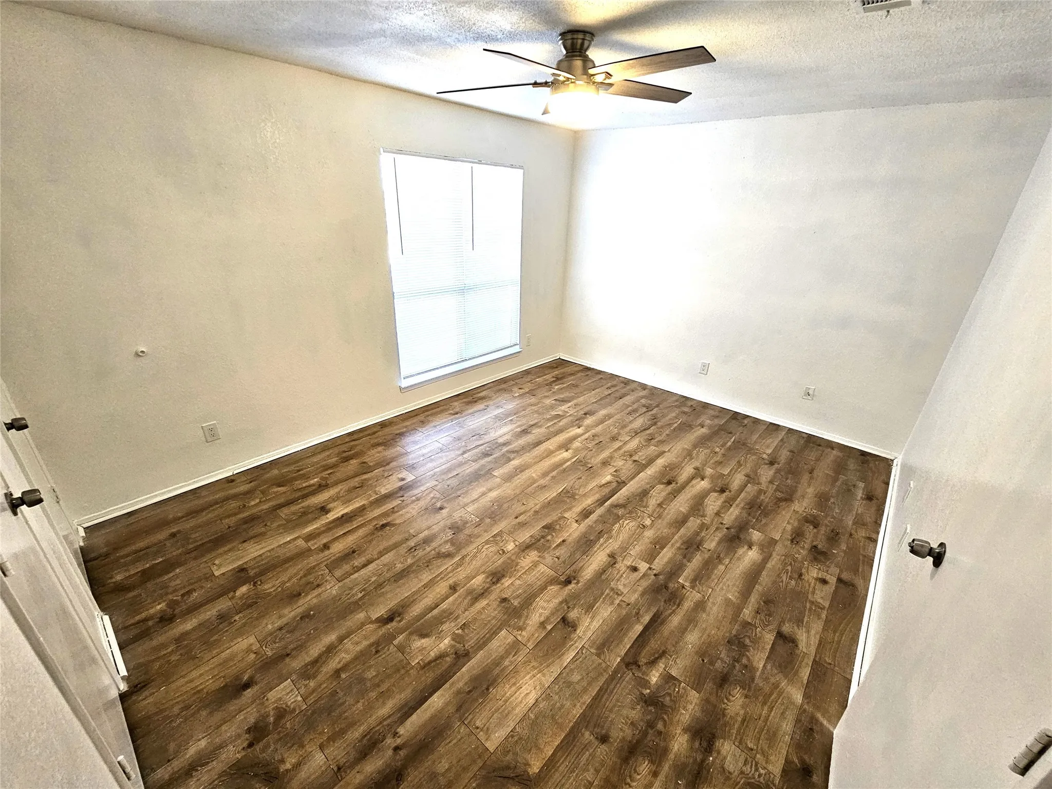 Bedroom #1-spacious bedroom (13x13) with new modern ceiling fan & wood laminate flooring - no carpet in this townhome. Stairs is wood laminate as well.