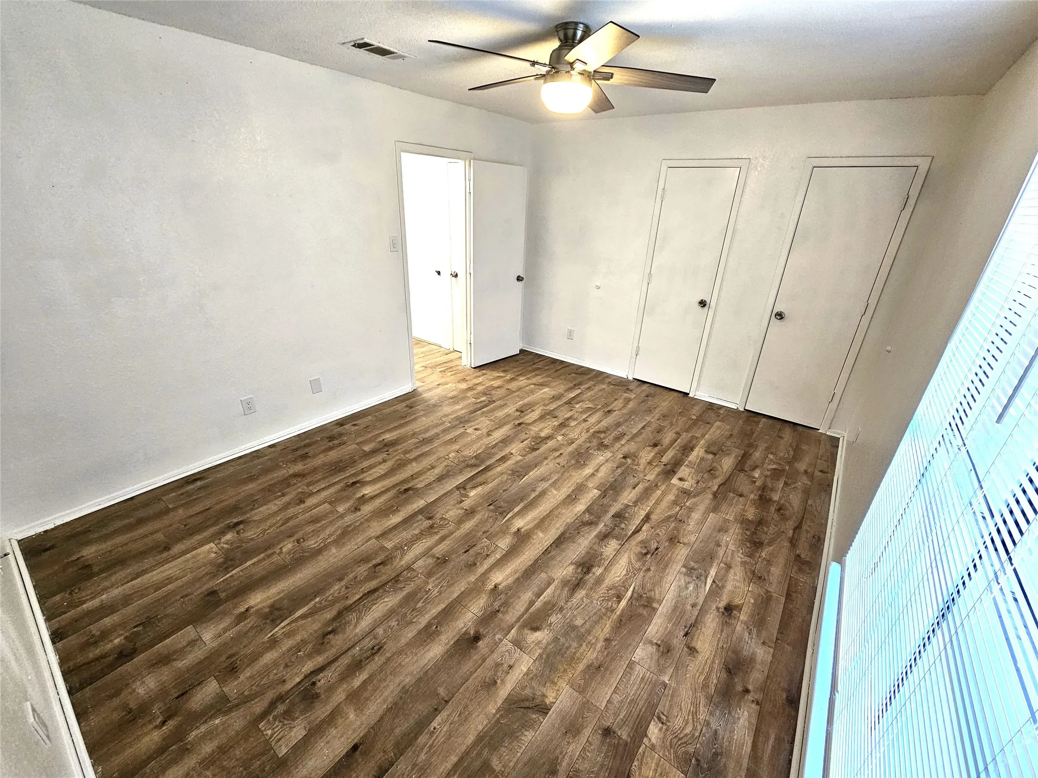 Bedroom #1-spacious bedroom (13x13) with new modern ceiling fan & wood laminate flooring - no carpet in this townhome. Stairs is wood laminate as well.