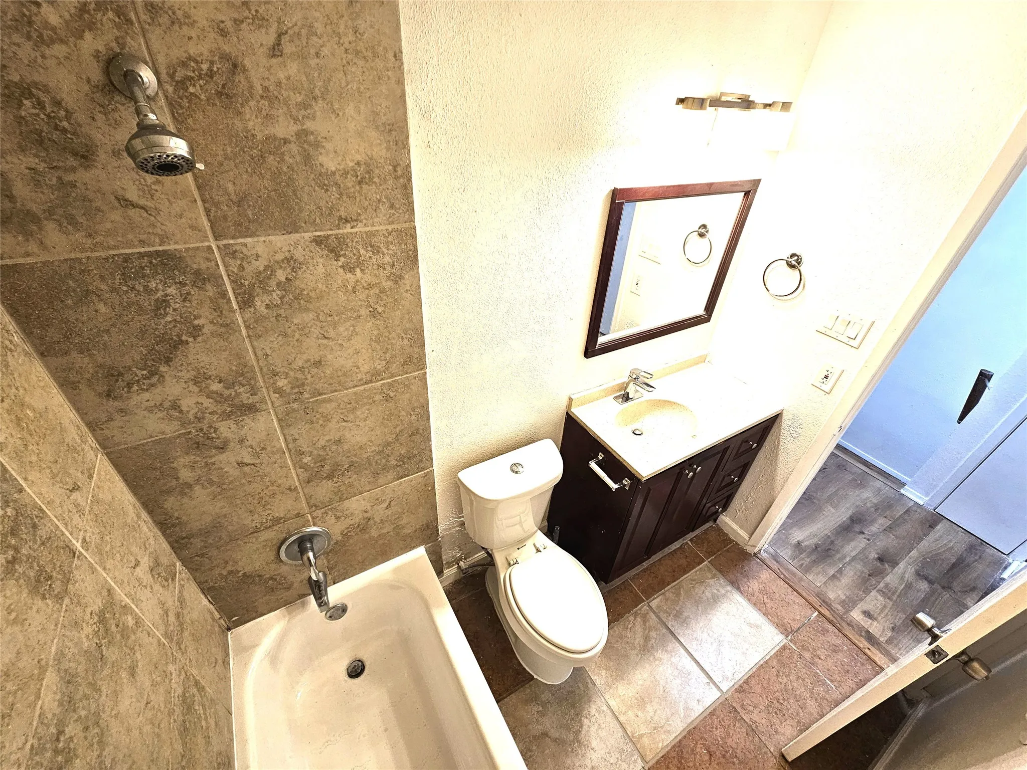 Full bathroom featuring vanity, tiled shower / bath combo, and toilet. It's upstairs in between 2 good size bedrooms.