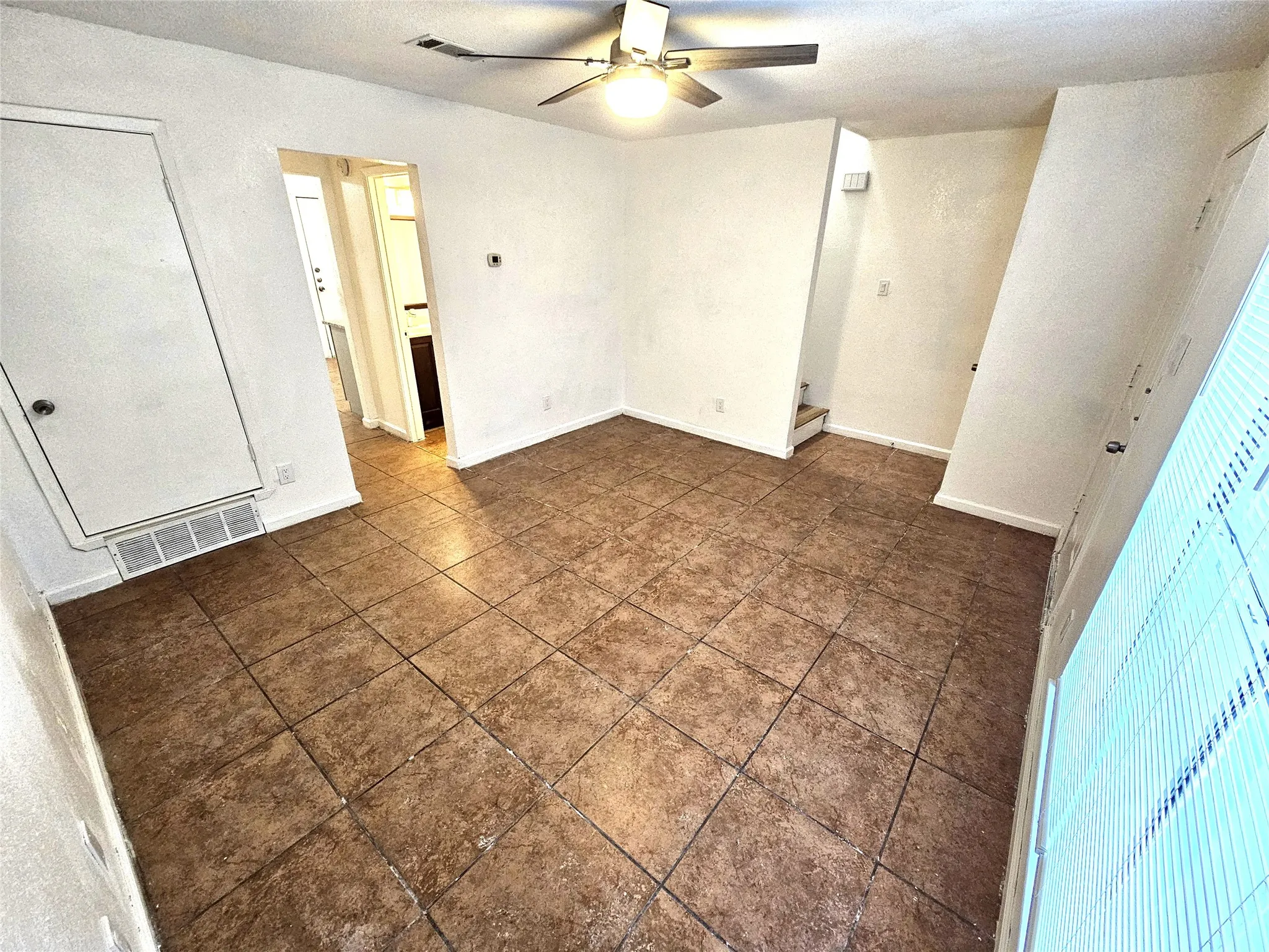 Family/Living room with new fresh paint and new ceiling fan.
