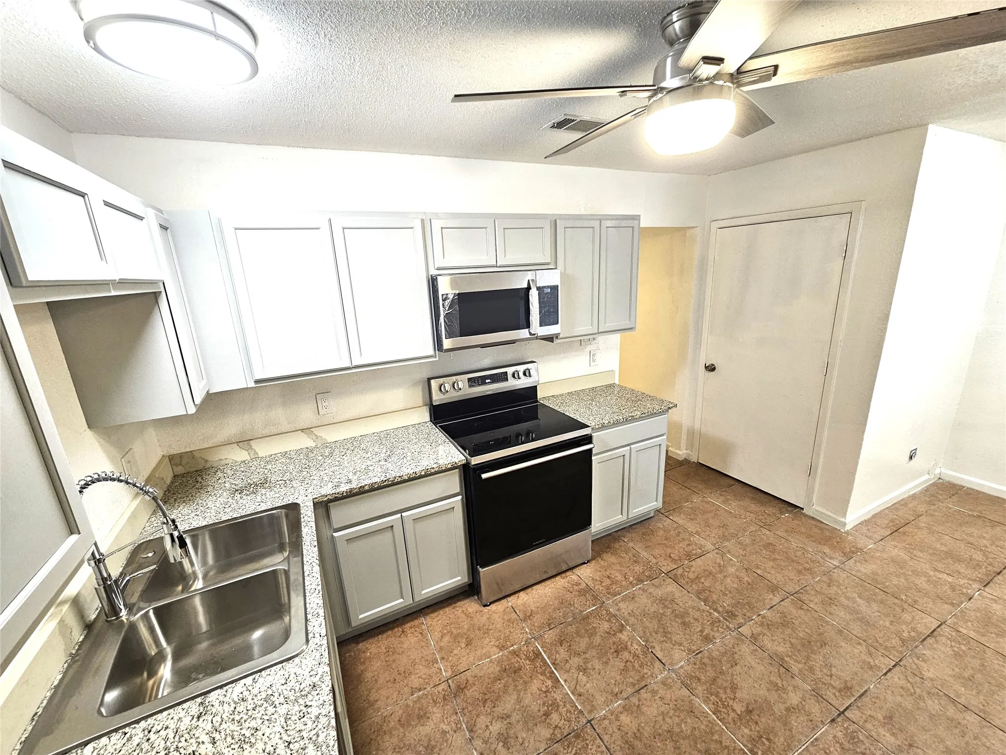 Newlly remodeled kitchen with lots of newly installed cabinets, new modern ceiling fan, modern light. New sink and faucet, new cabinets, granite countertop. new appliances.