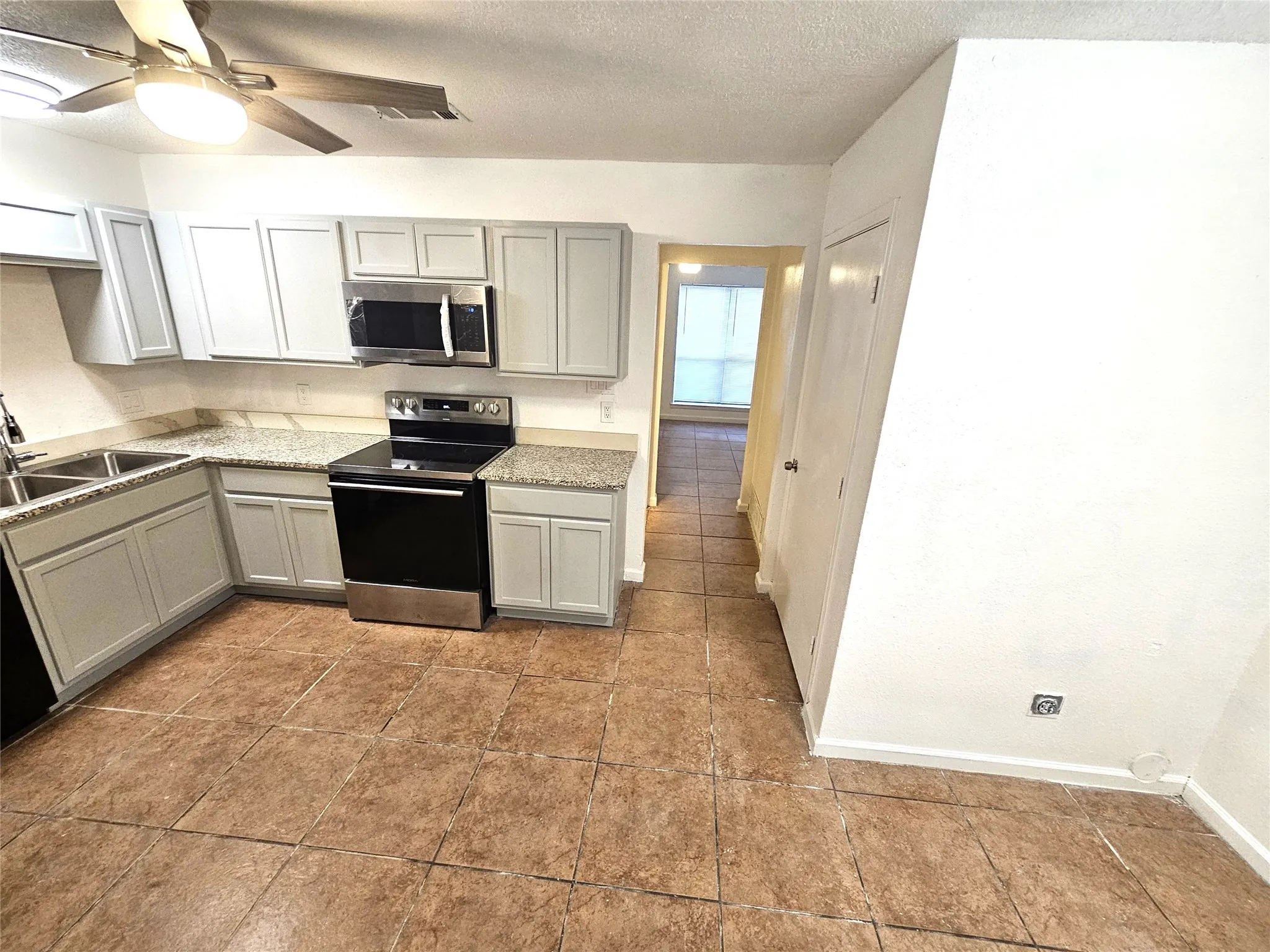 Newlly remodeled kitchen with lots of newly installed cabinets, new modern ceiling fan, modern light. New sink and faucet, new cabinets, granite countertop. new appliances.