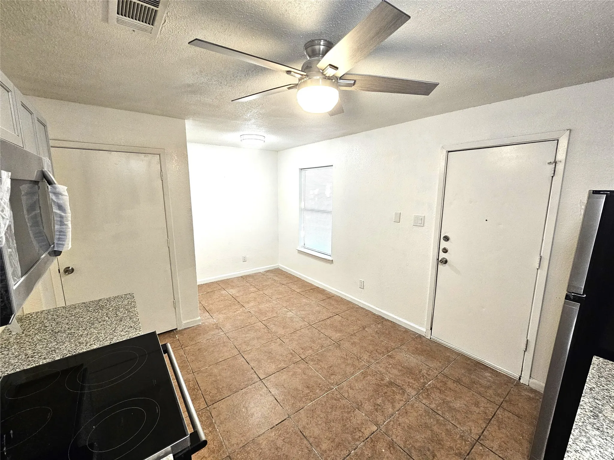 Newlly remodeled kitchen with lots of newly installed cabinets, new modern ceiling fan, modern light. New sink and faucet, new cabinets, granite countertop. new appliances.