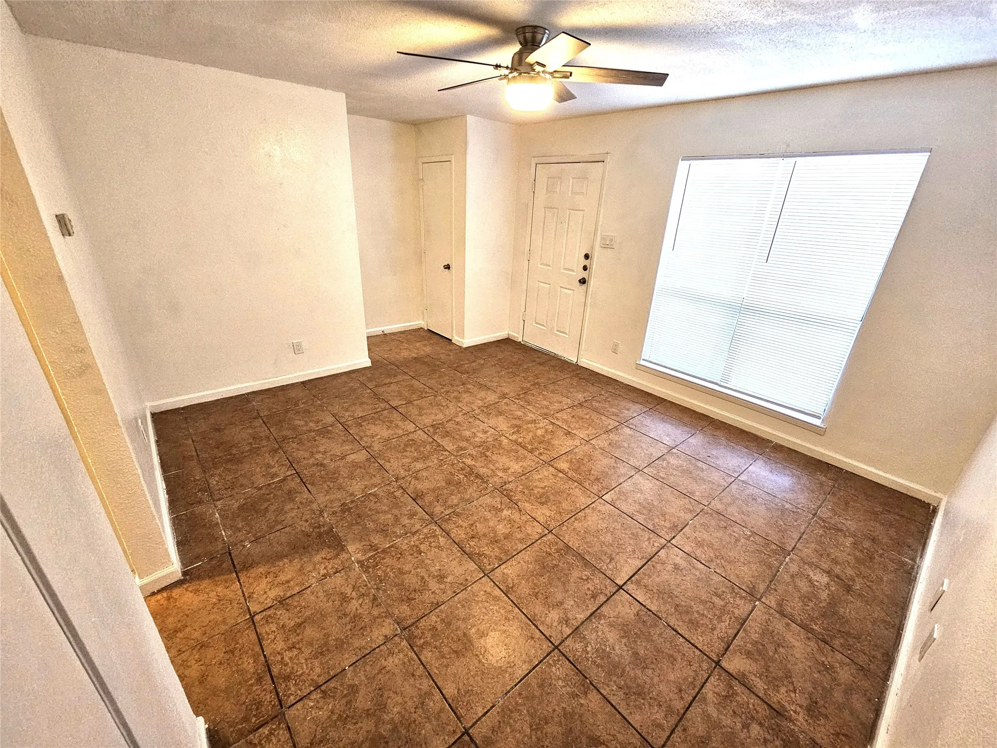 Family/Living room with new fresh paint and new ceiling fan.