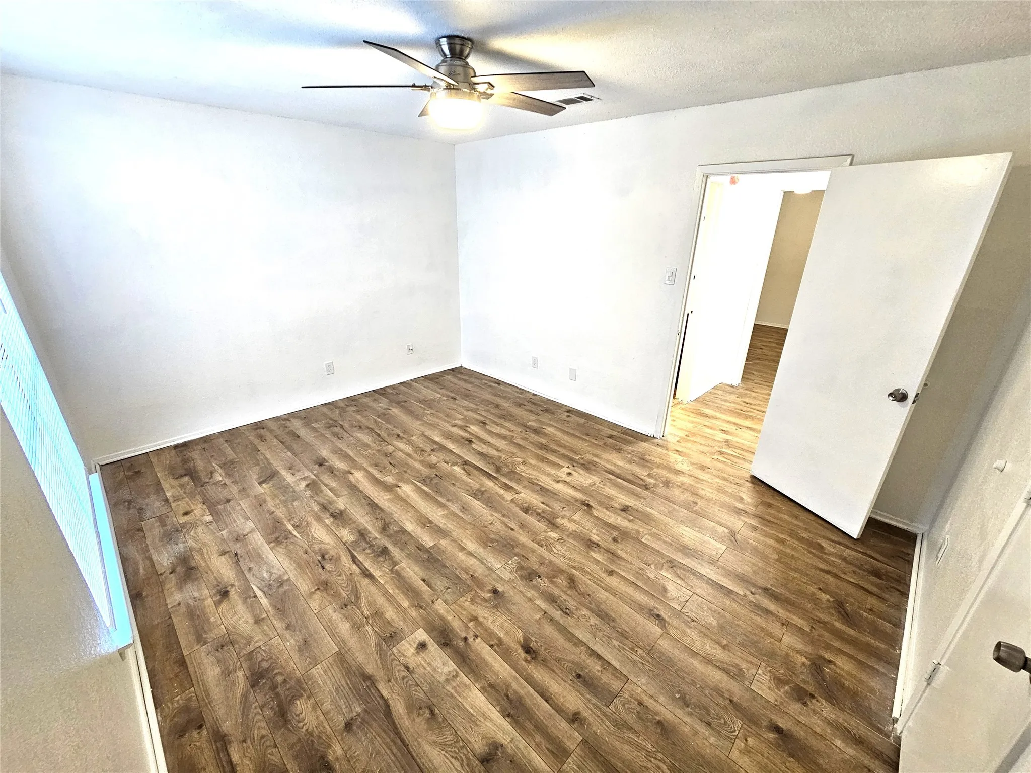 Bedroom #1-spacious bedroom (13x13) with new modern ceiling fan & wood laminate flooring - no carpet in this townhome. Stairs is wood laminate as well.