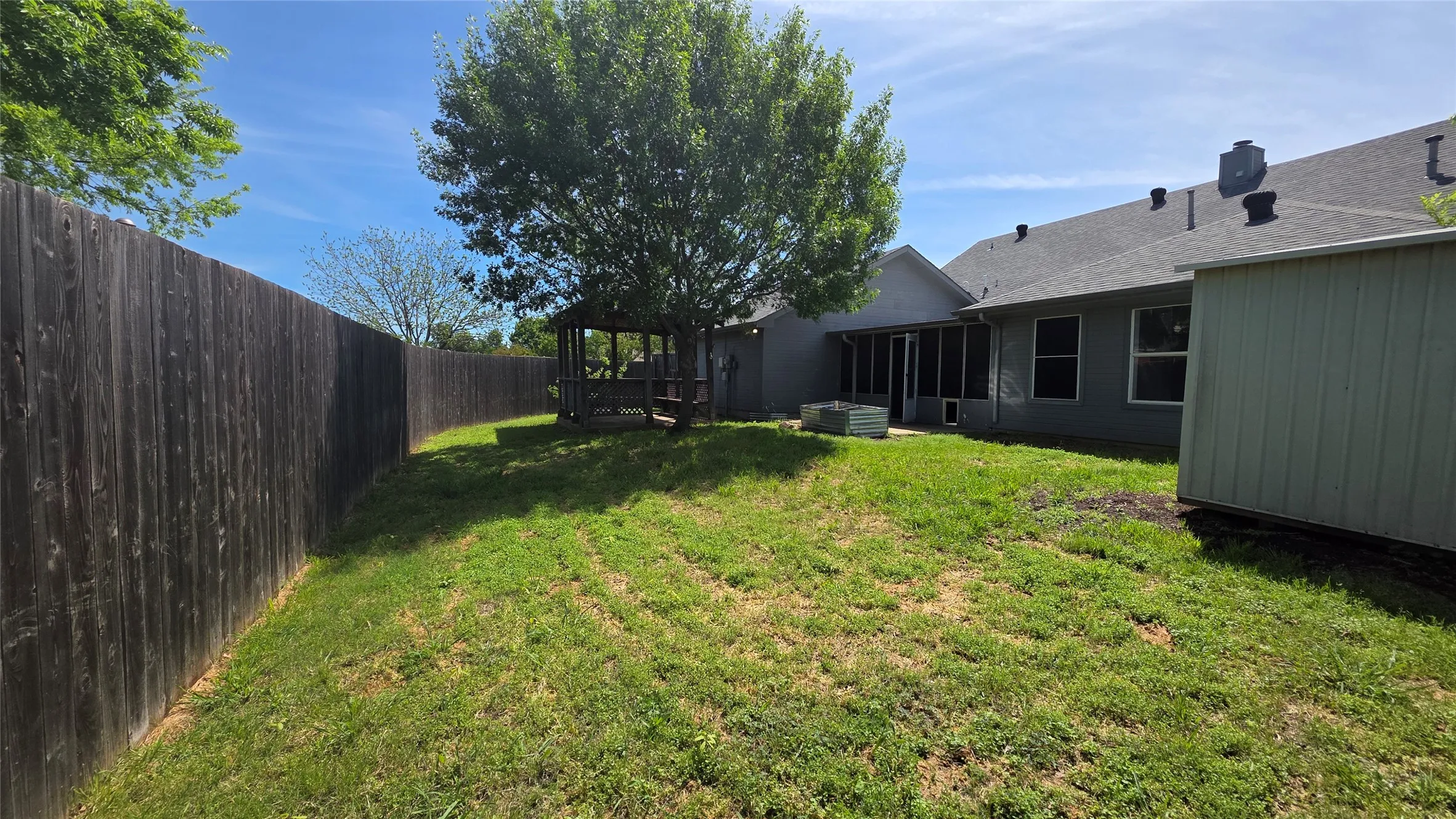 View of fenced backyard