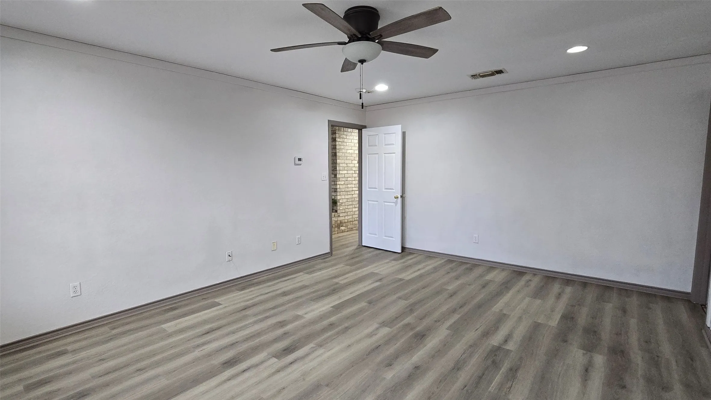 Unfurnished room with crown molding, ceiling fan, recessed lighting, and light wood-type flooring