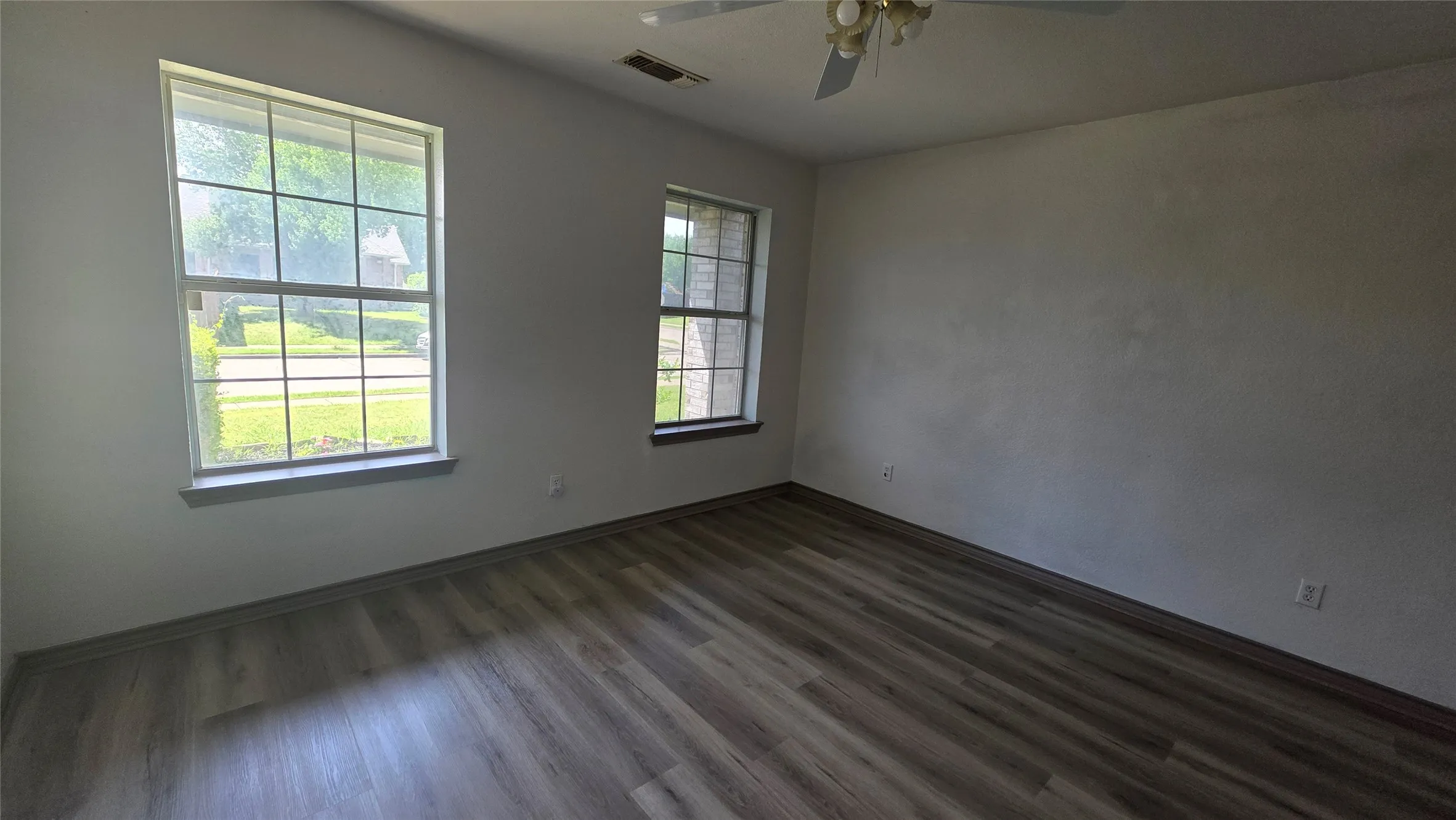 Bedroom featuring dark wood-type flooring and a ceiling fan