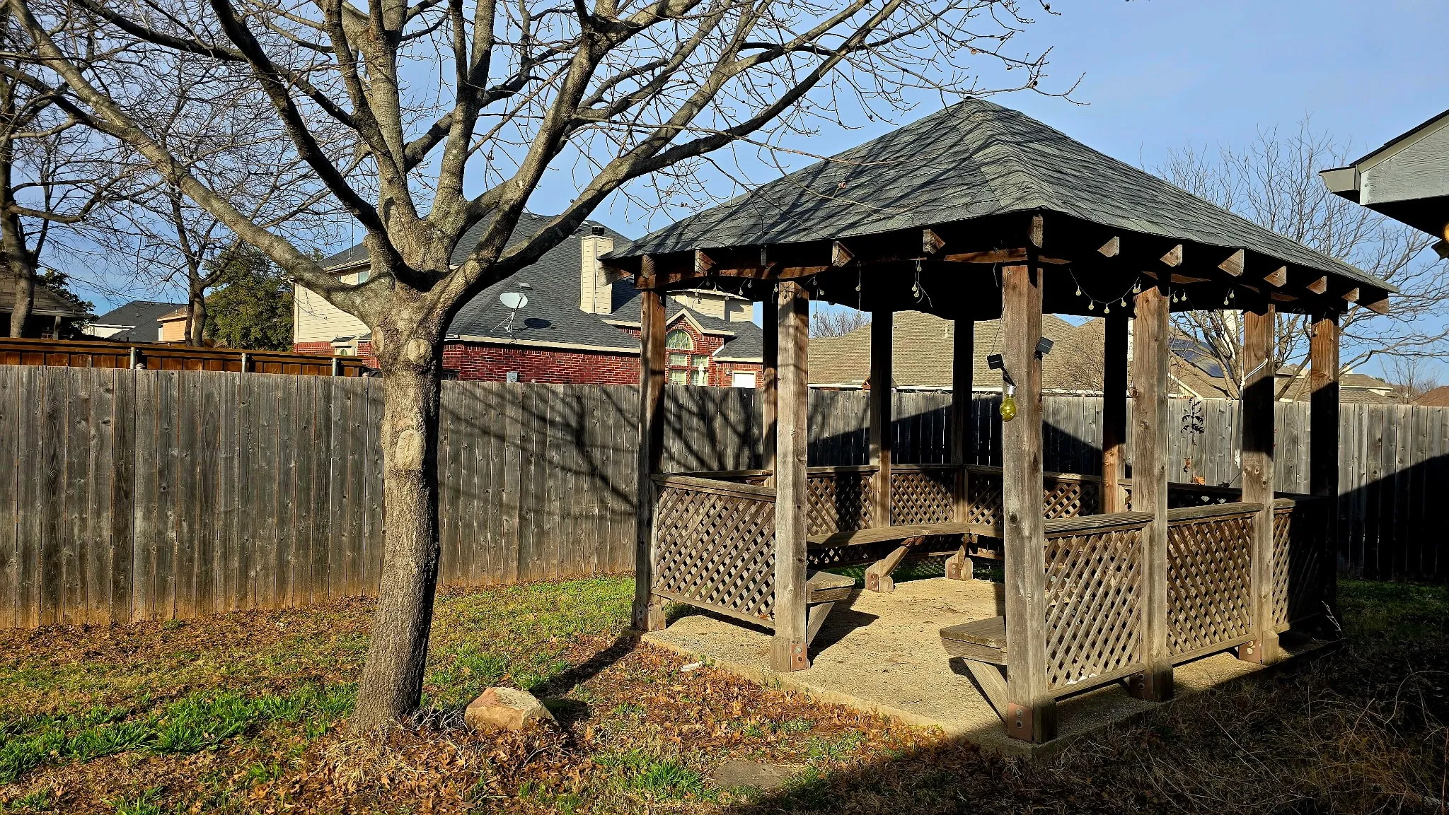 Fenced backyard with a gazebo and a patio area