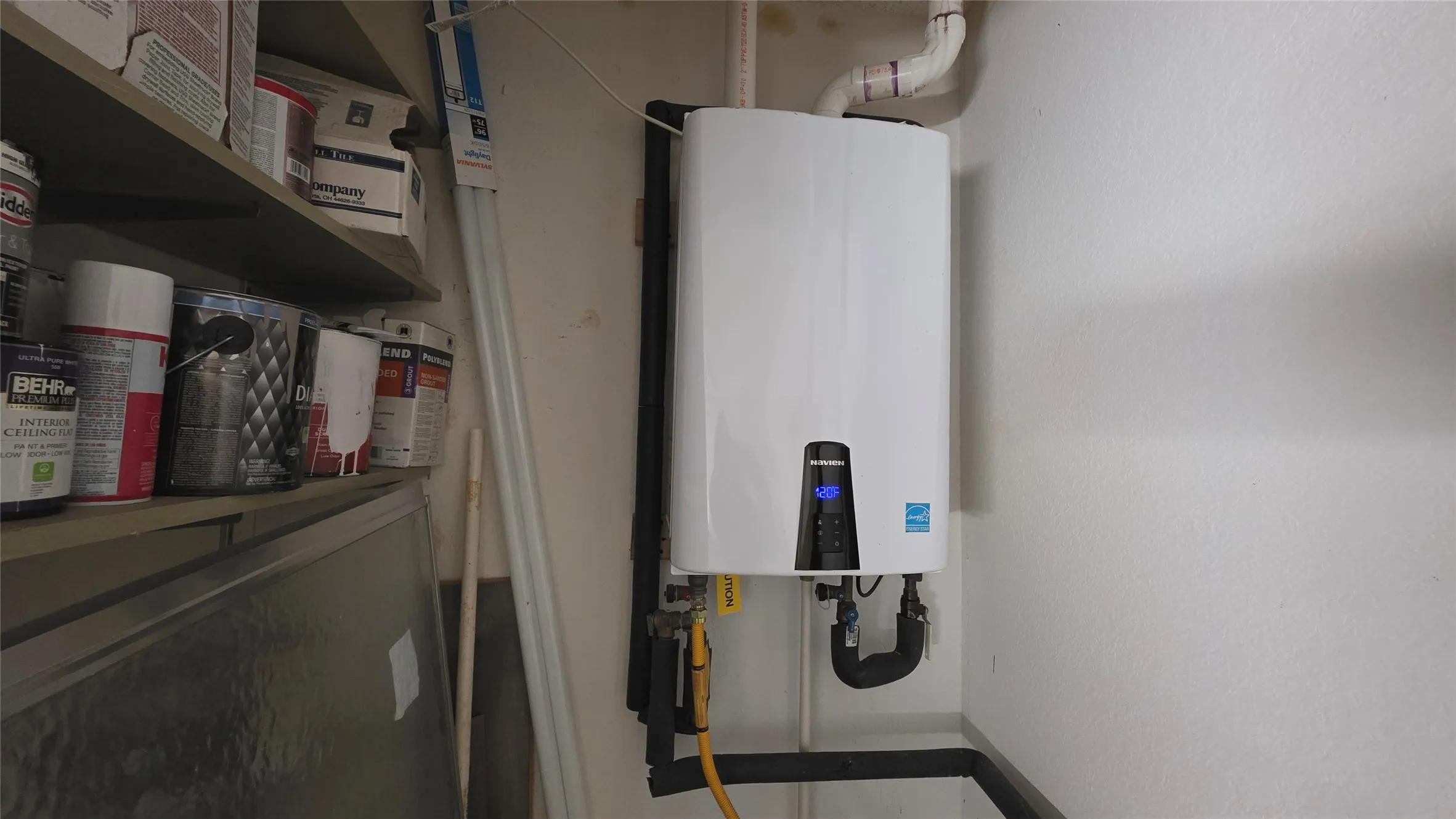 Utility room featuring tankless water heater