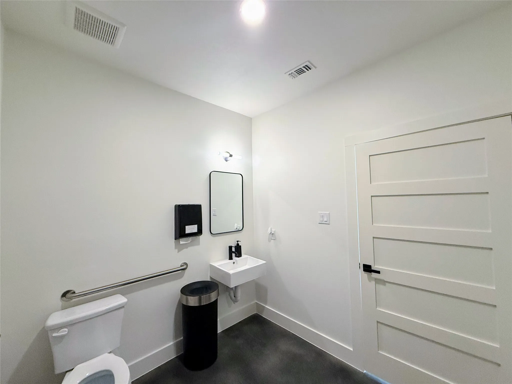 Half bathroom featuring toilet and baseboards