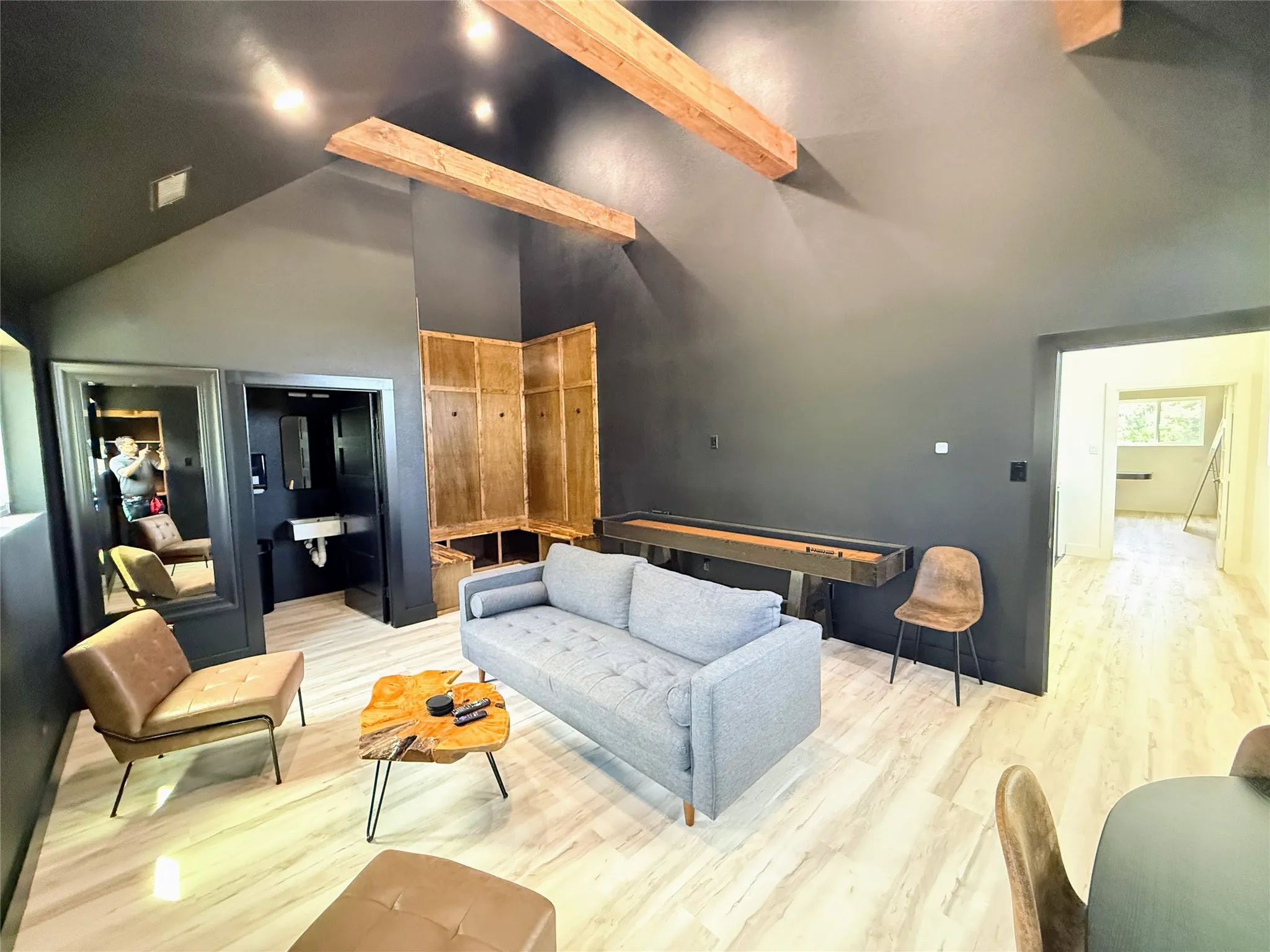 Living room featuring wood finished floors, high vaulted ceiling, and beam ceiling
