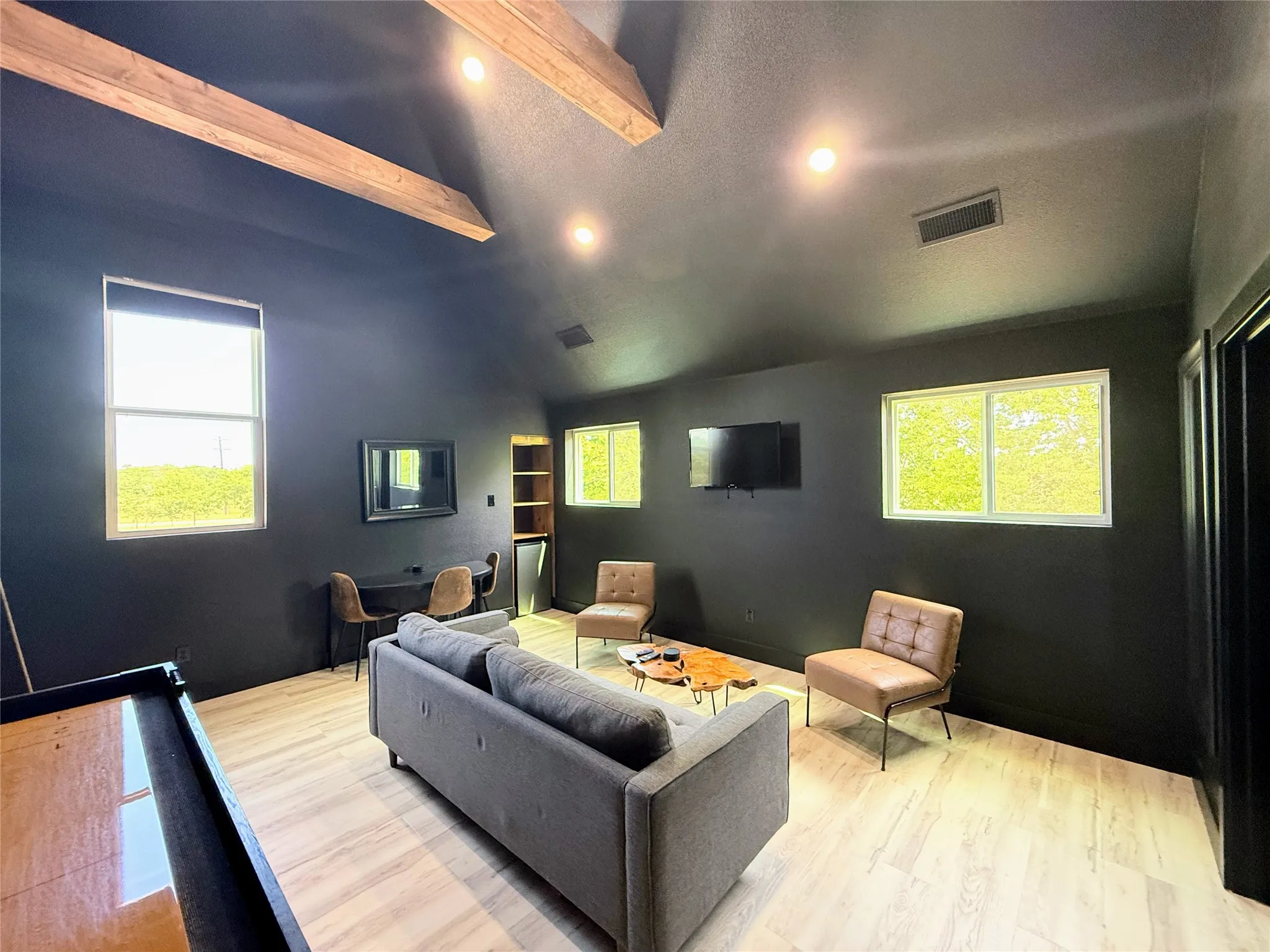 Home theater with wood finished floors, recessed lighting, and a textured ceiling