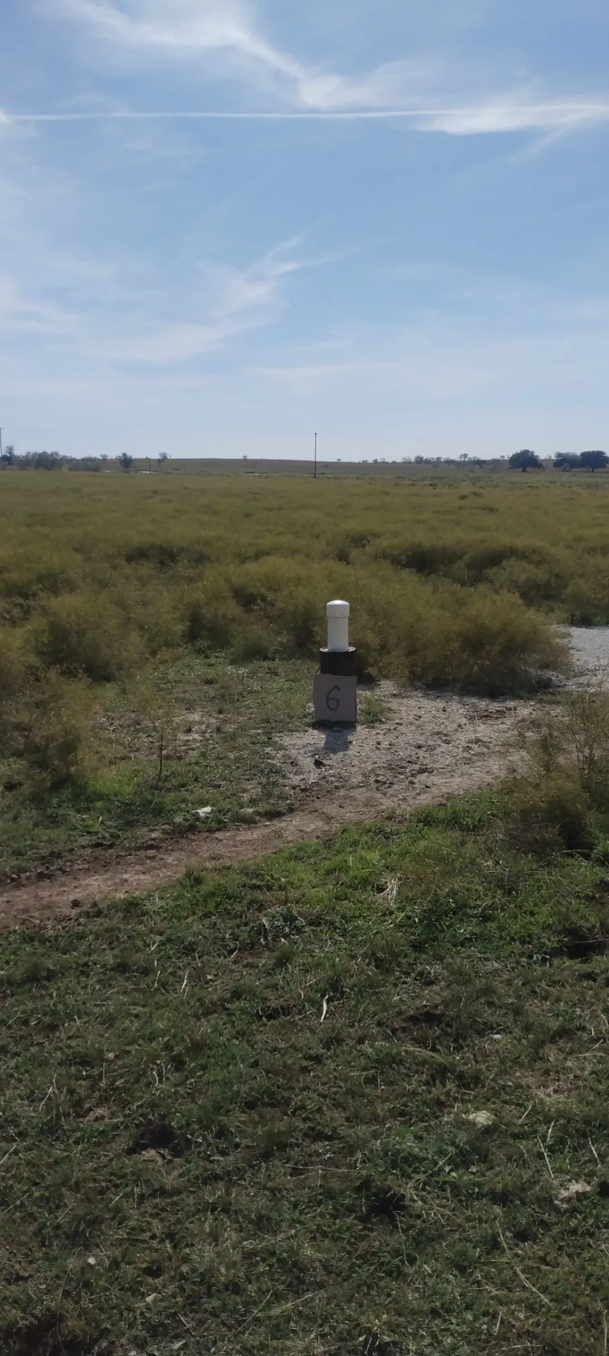 View of storm shelter with a rural view