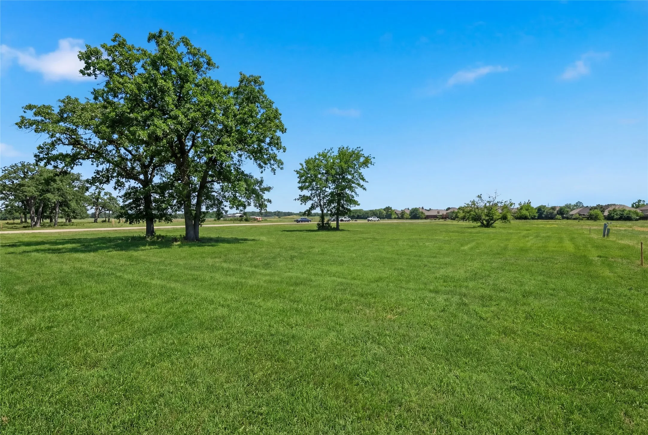 This is a photograph of Lot 13 Block H and was captured in February. It has been digitally enhanced to emphasize the presence of leaves and grass.