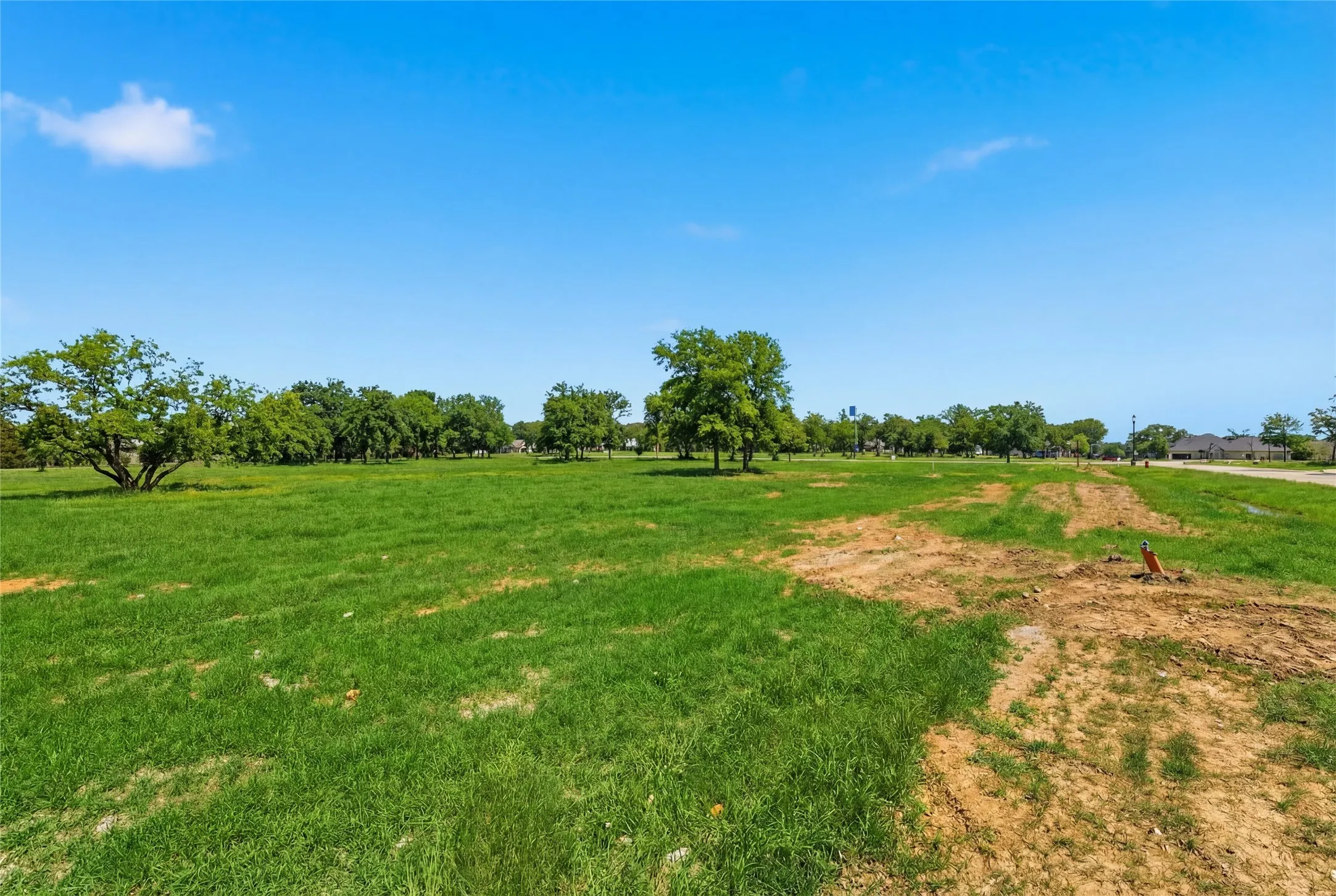 This is a photograph of Lot 13 Block H and was captured in February. It has been digitally enhanced to emphasize the presence of leaves and grass.