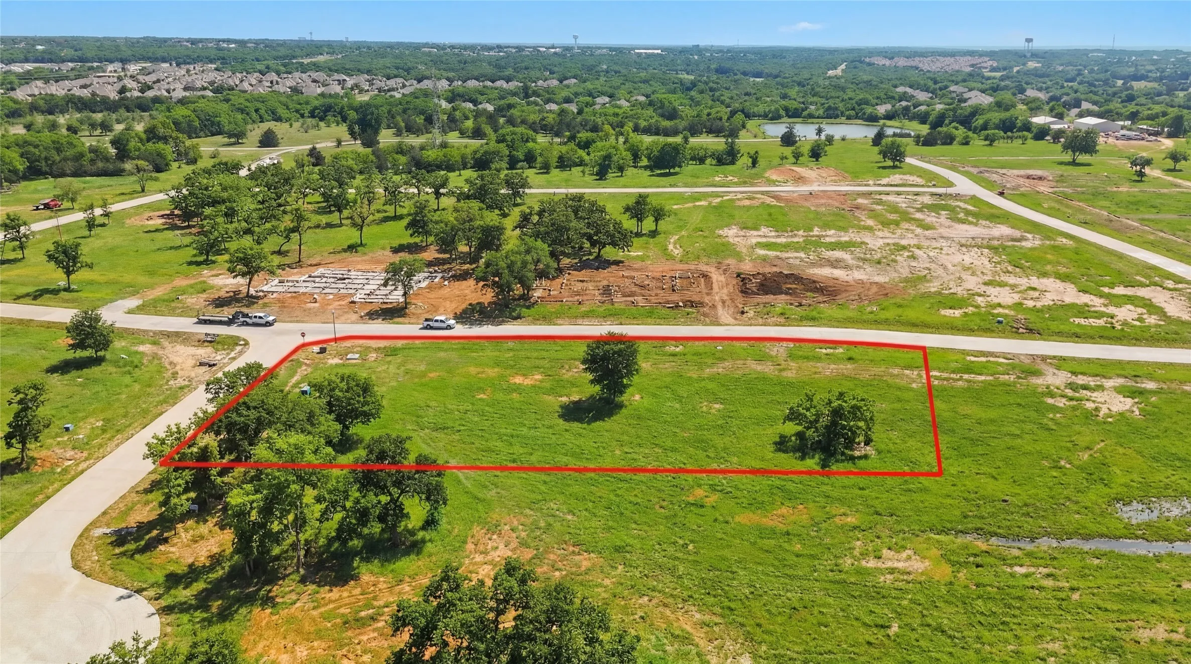 This is an aerial photograph of Lot 13 Block H and was captured in February. It has been digitally enhanced to emphasize the presence of leaves and grass.