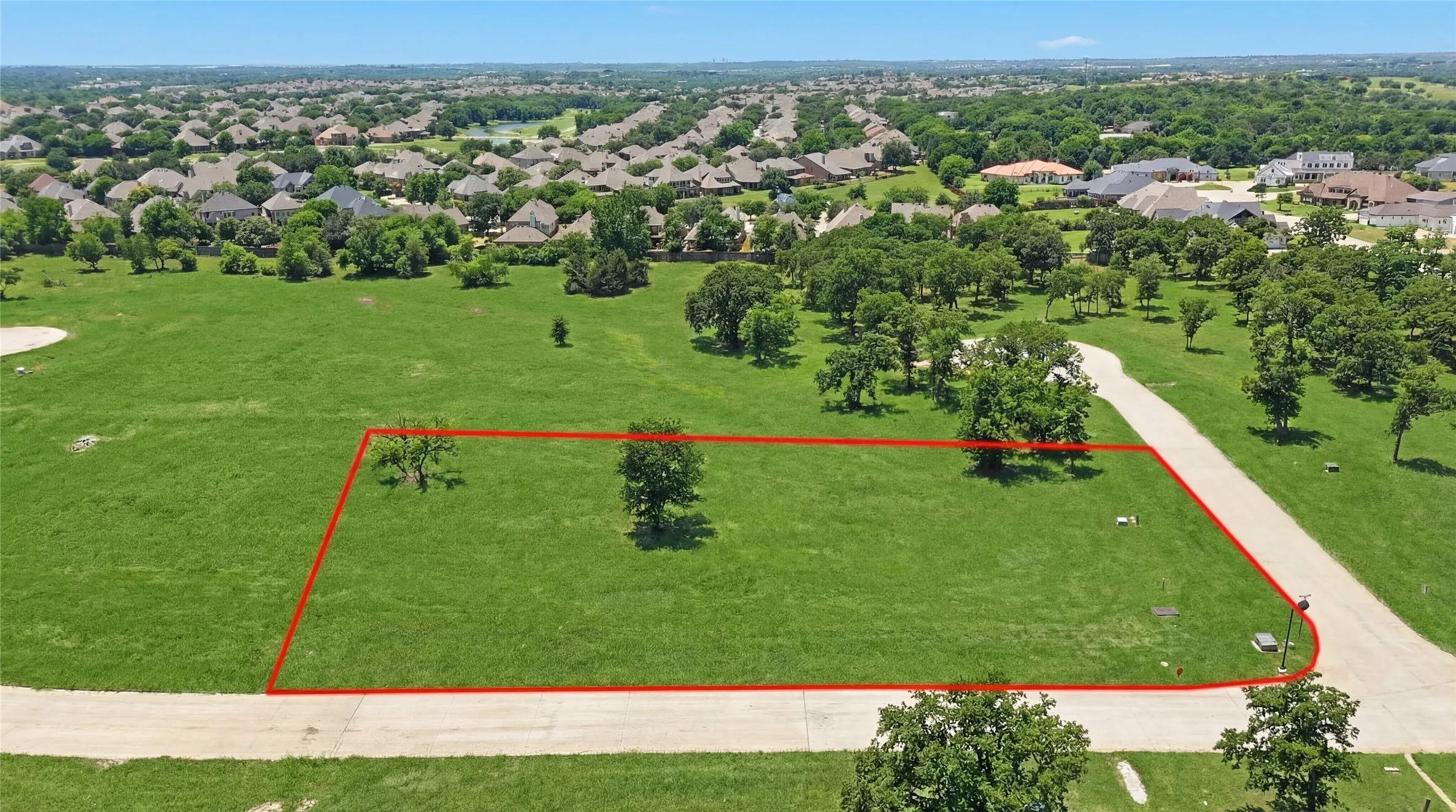 This is an aerial photograph of Lot 13 Block H and was captured in February. It has been digitally enhanced to emphasize the presence of leaves and grass.