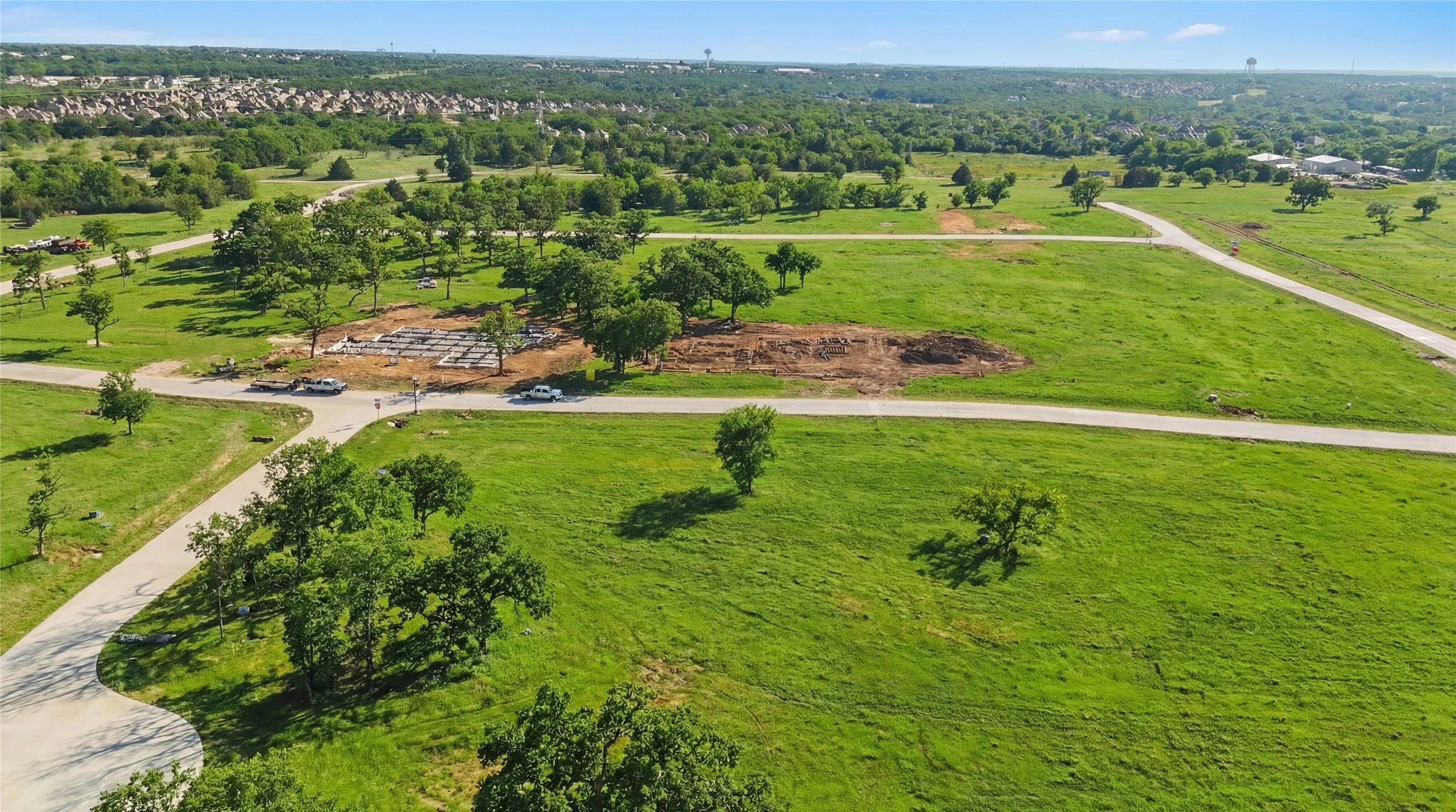 This is an aerial photograph of Lot 13 Block H and was captured in February. It has been digitally enhanced to emphasize the presence of leaves and grass.