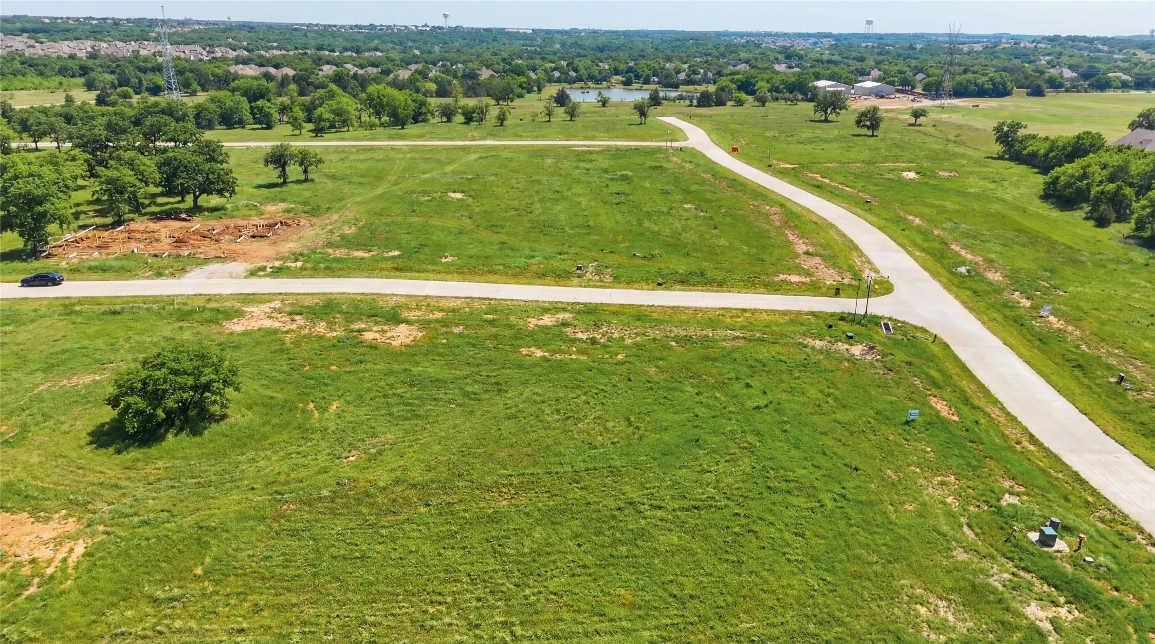 This is an aerial photograph of Lot 12 Block H and was captured in February. It has been digitally enhanced to emphasize the presence of leaves and grass.