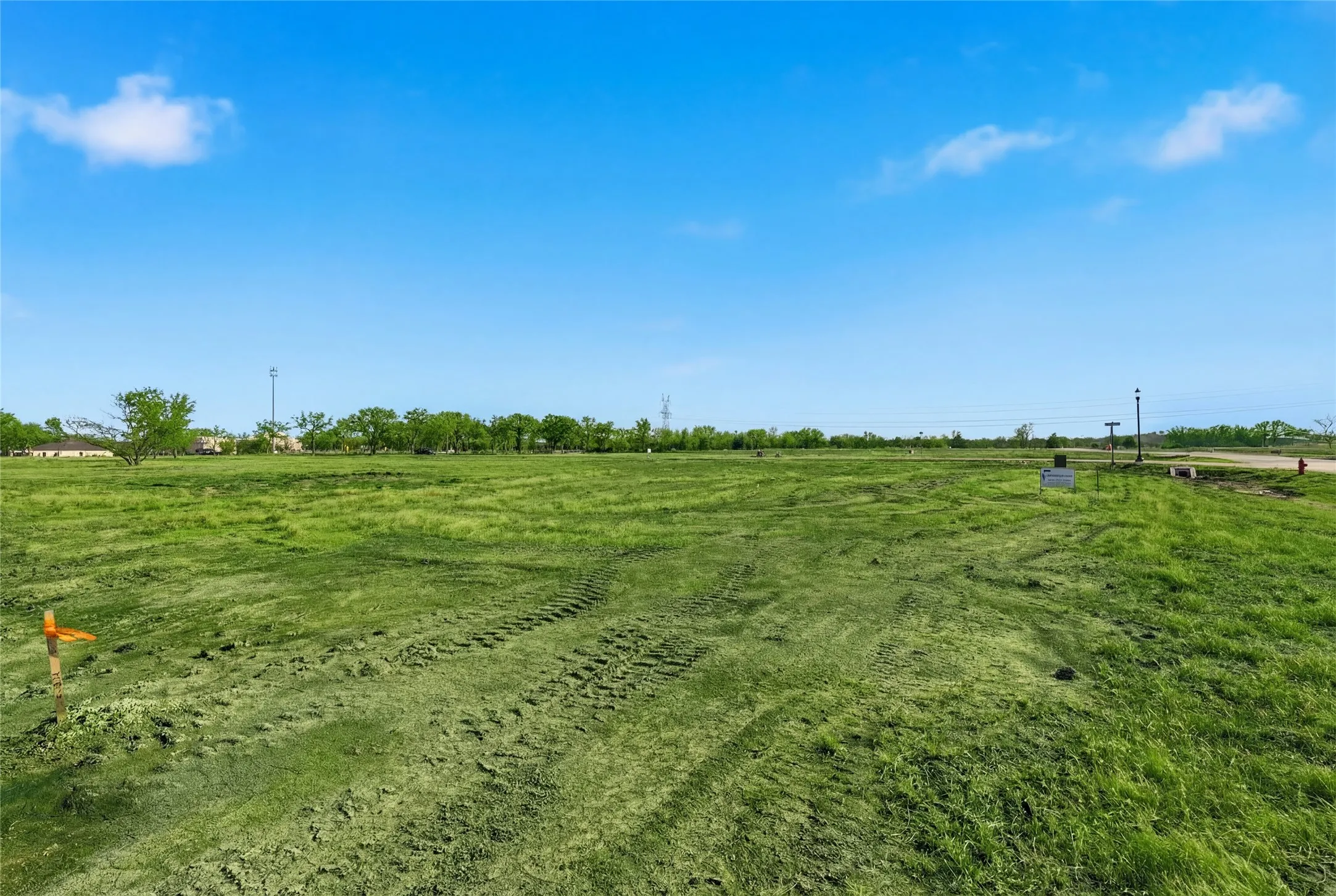 This is a photograph of Lot 12 Block H and was captured in February. It has been digitally enhanced to emphasize the presence of leaves and grass.