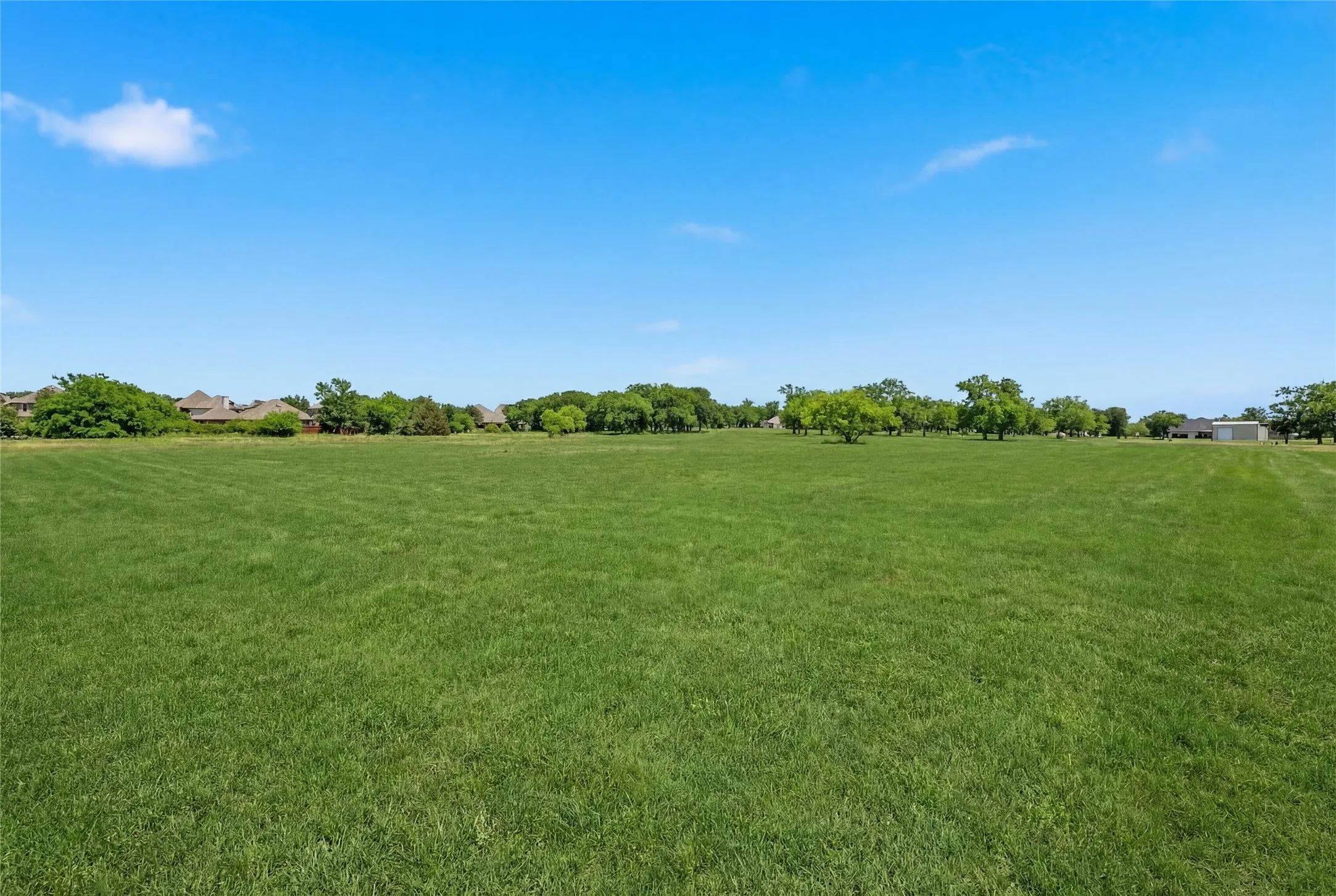 This is a photograph of Lot 12 Block H and was captured in February. It has been digitally enhanced to emphasize the presence of leaves and grass.