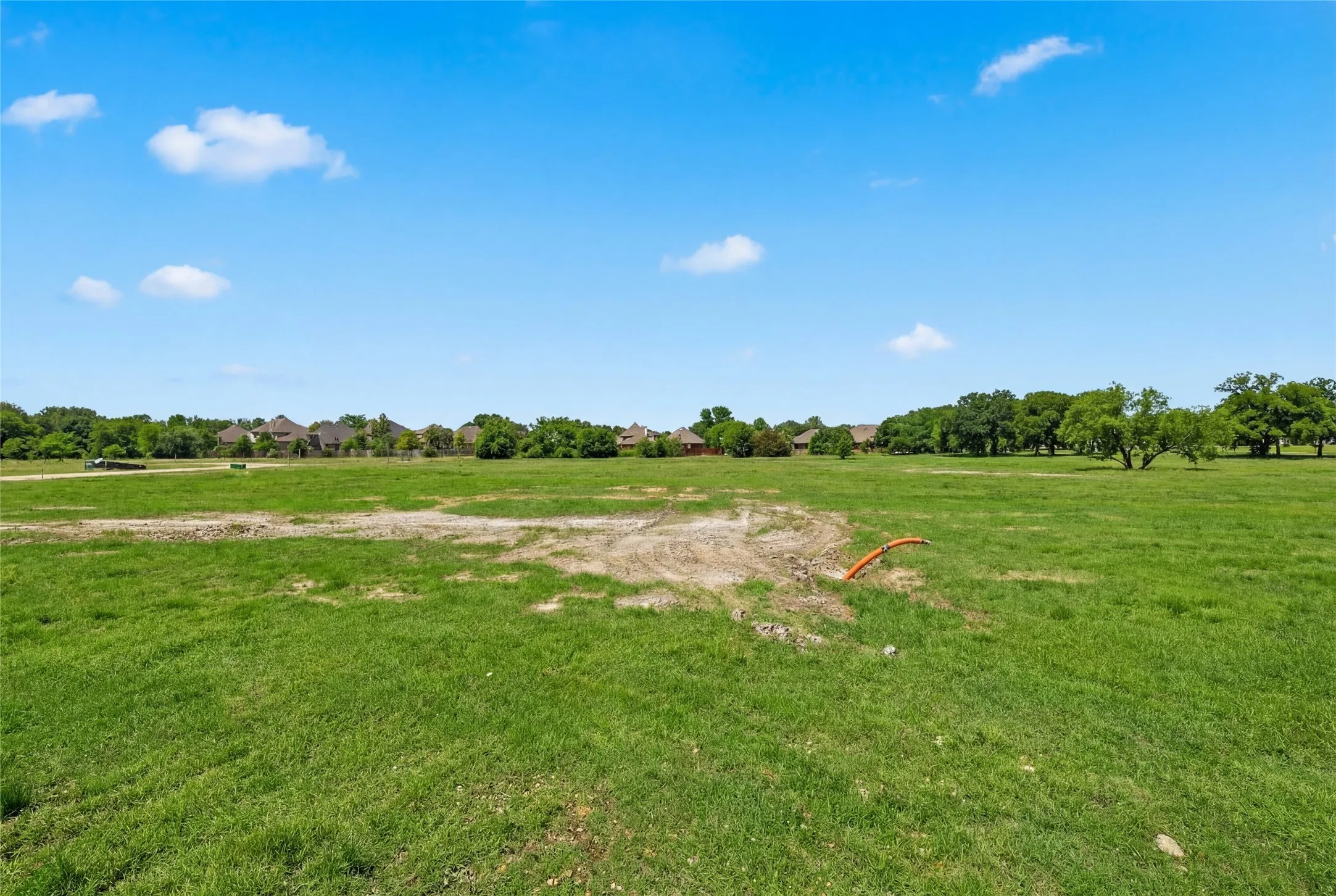 This is a photograph of Lot 12 Block H and was captured in February. It has been digitally enhanced to emphasize the presence of leaves and grass.