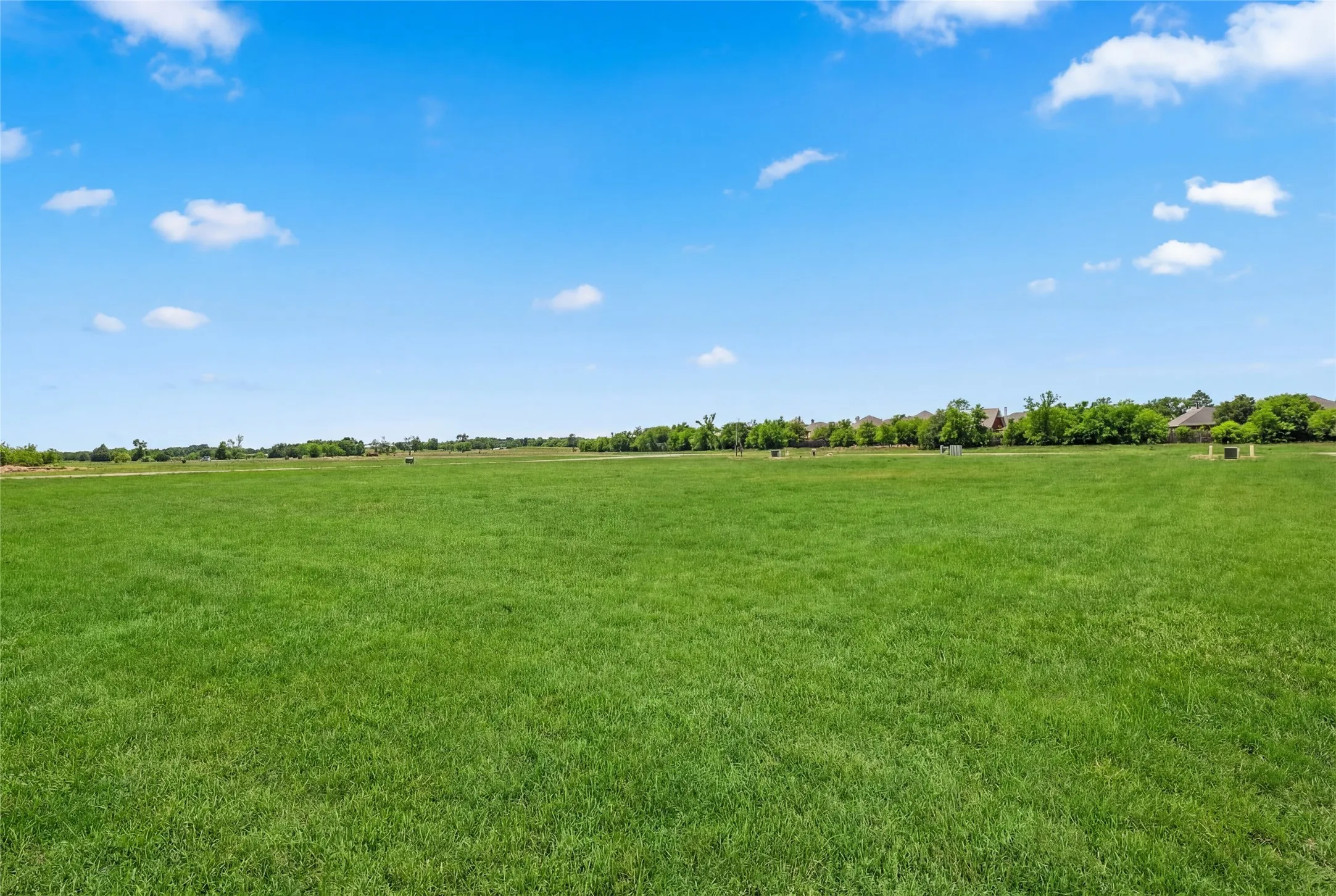 This is a photograph of Lot 12 Block H and was captured in February. It has been digitally enhanced to emphasize the presence of leaves and grass.