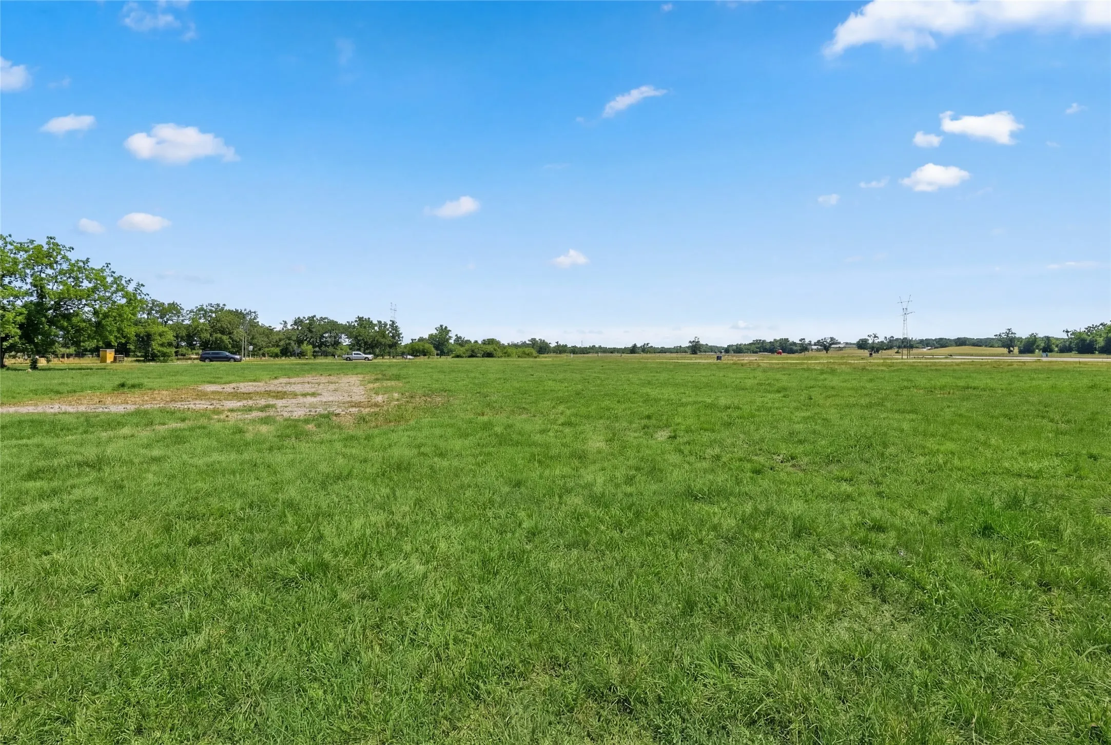 This is a photograph of Lot 12 Block H and was captured in February. It has been digitally enhanced to emphasize the presence of leaves and grass.