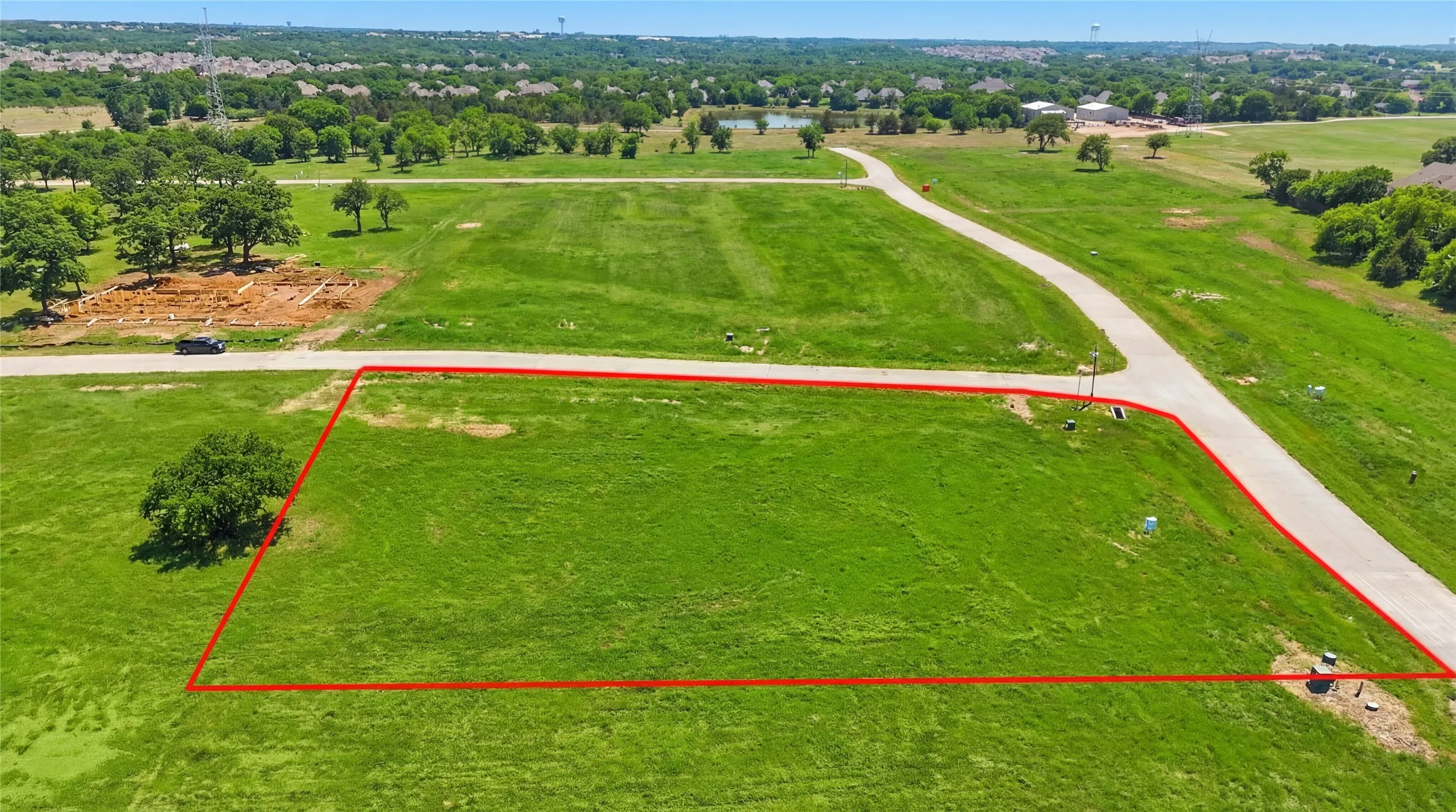 This is an aerial photograph of Lot 12 Block H and was captured in February. It has been digitally enhanced to emphasize the presence of leaves and grass.