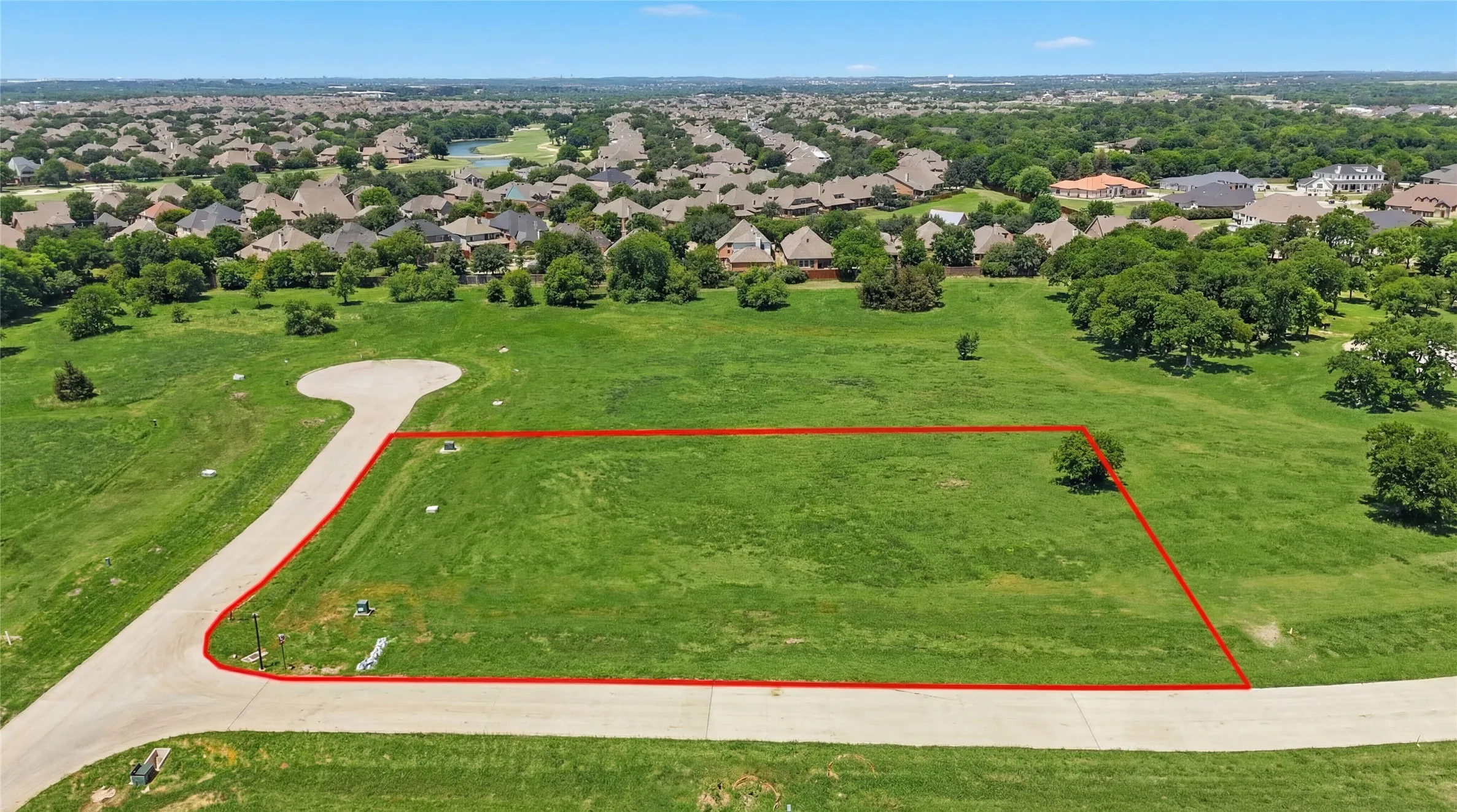 This is an aerial photograph of Lot 12 Block H and was captured in February. It has been digitally enhanced to emphasize the presence of leaves and grass.