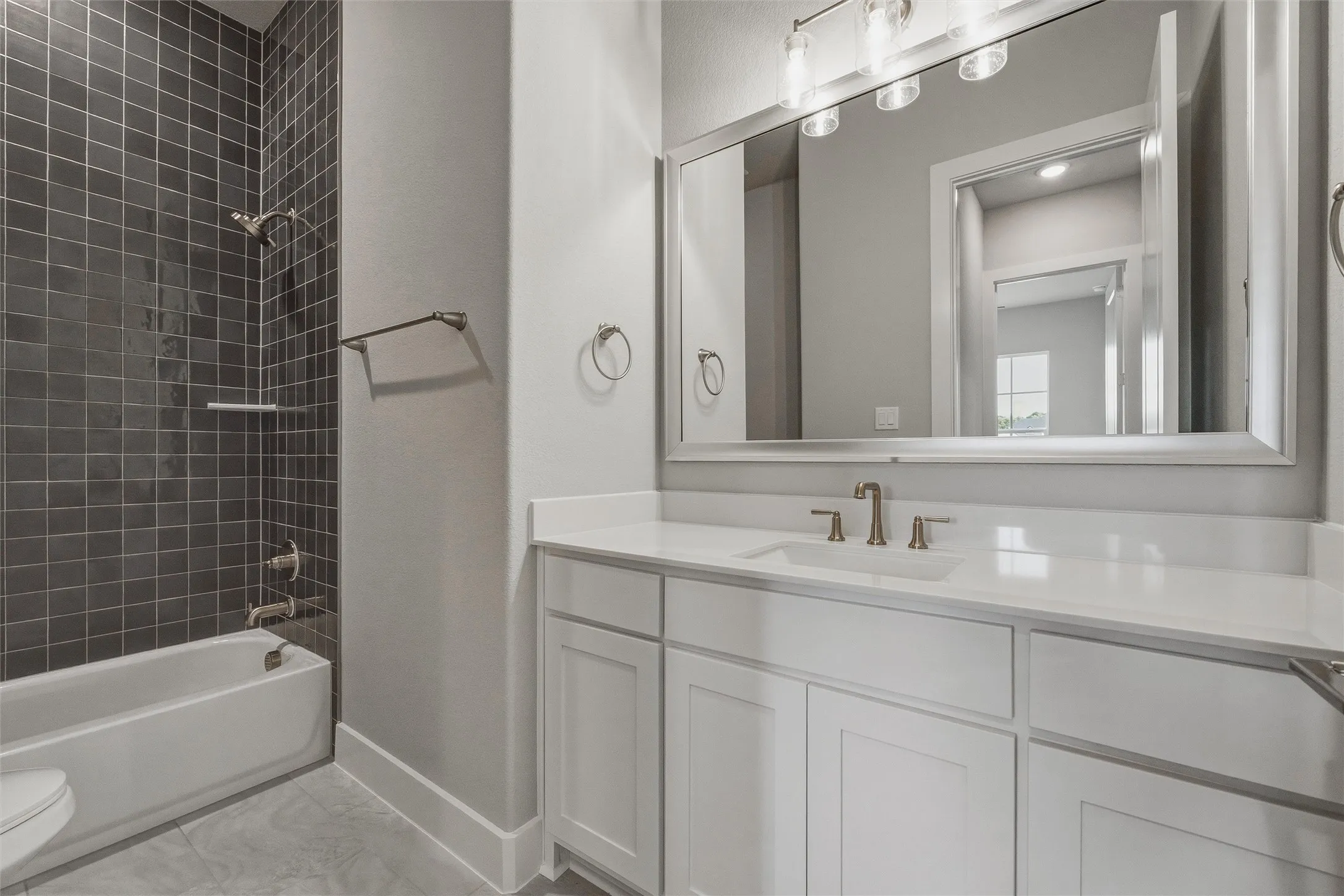 White vanity with a single basin, light-toned countertop, and brushed nickel fixtures