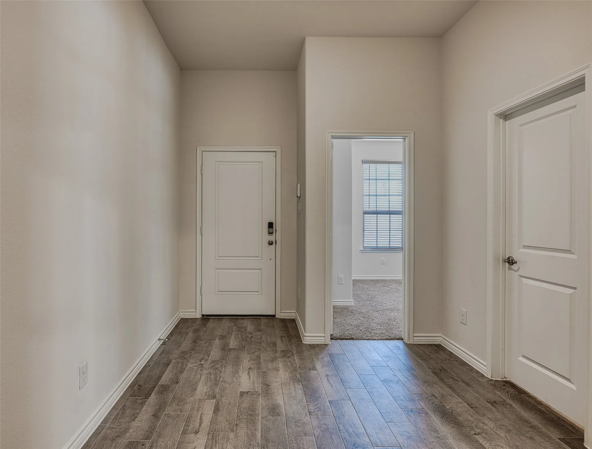 Entrance foyer featuring hardwood / wood-style flooring and baseboards