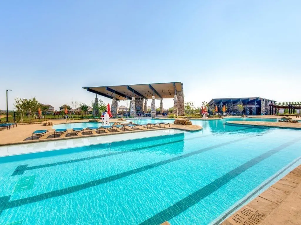 Community pool with a patio